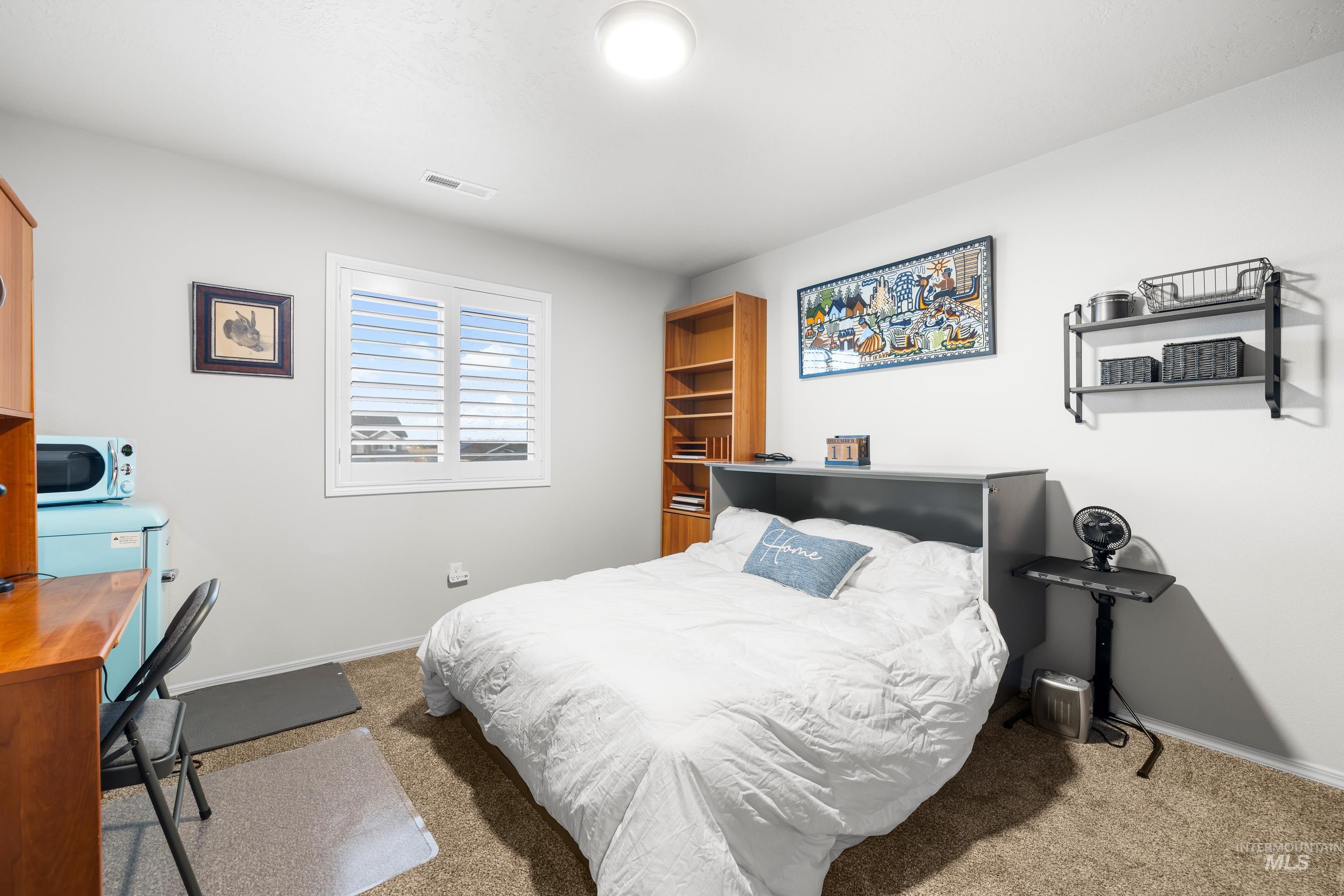 Bedroom with light colored carpet