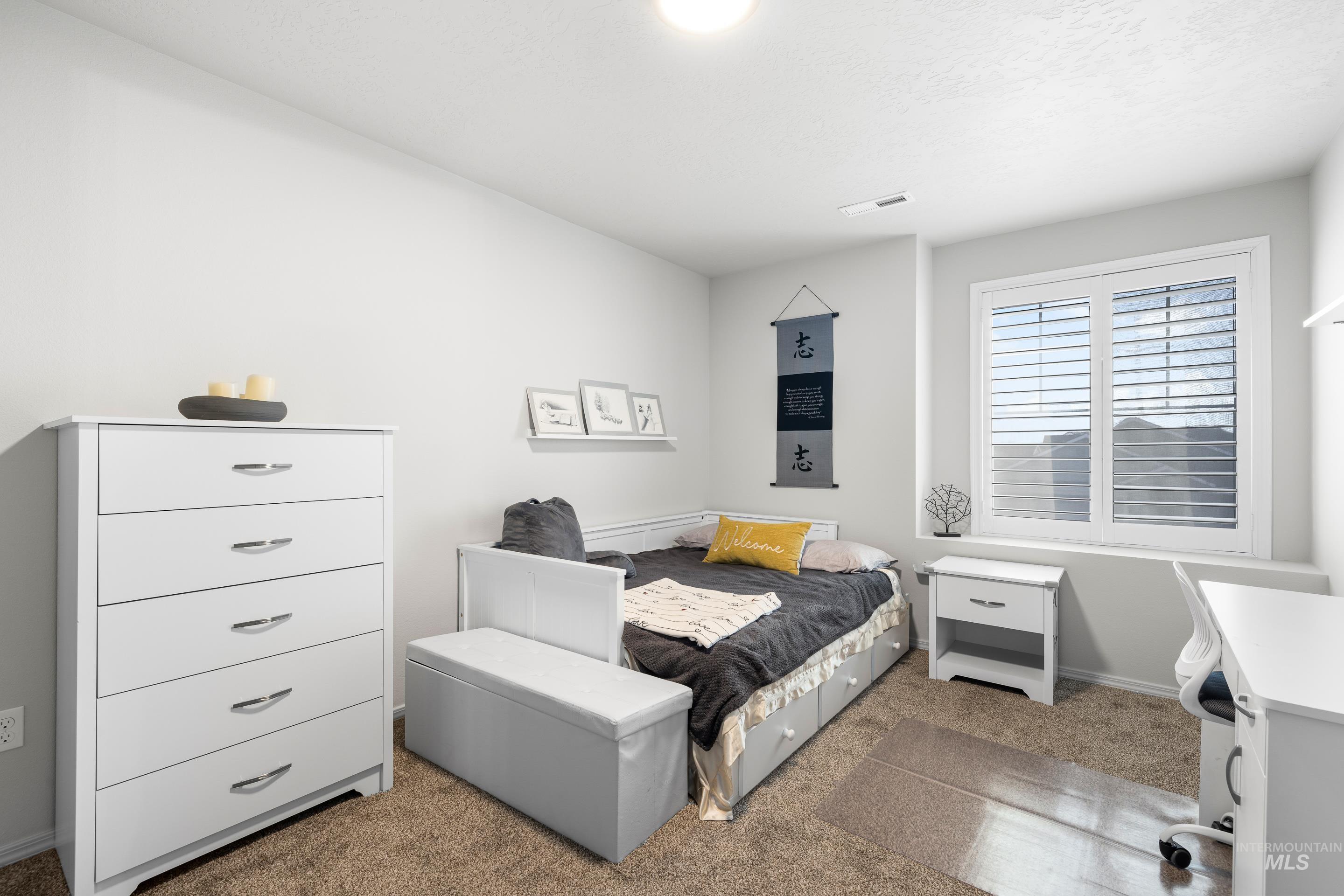 Carpeted bedroom featuring baseboards