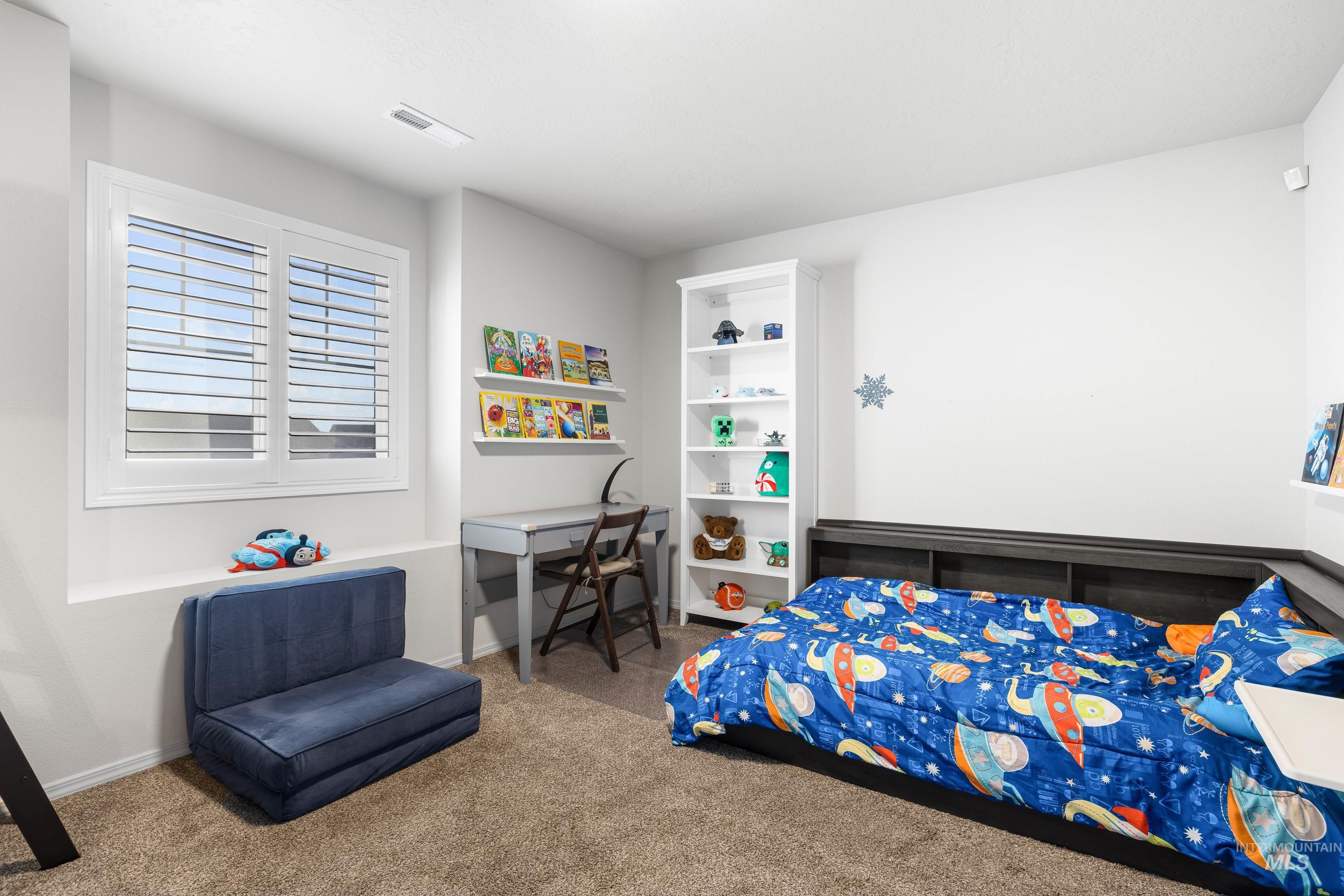 Bedroom with carpet flooring and baseboards