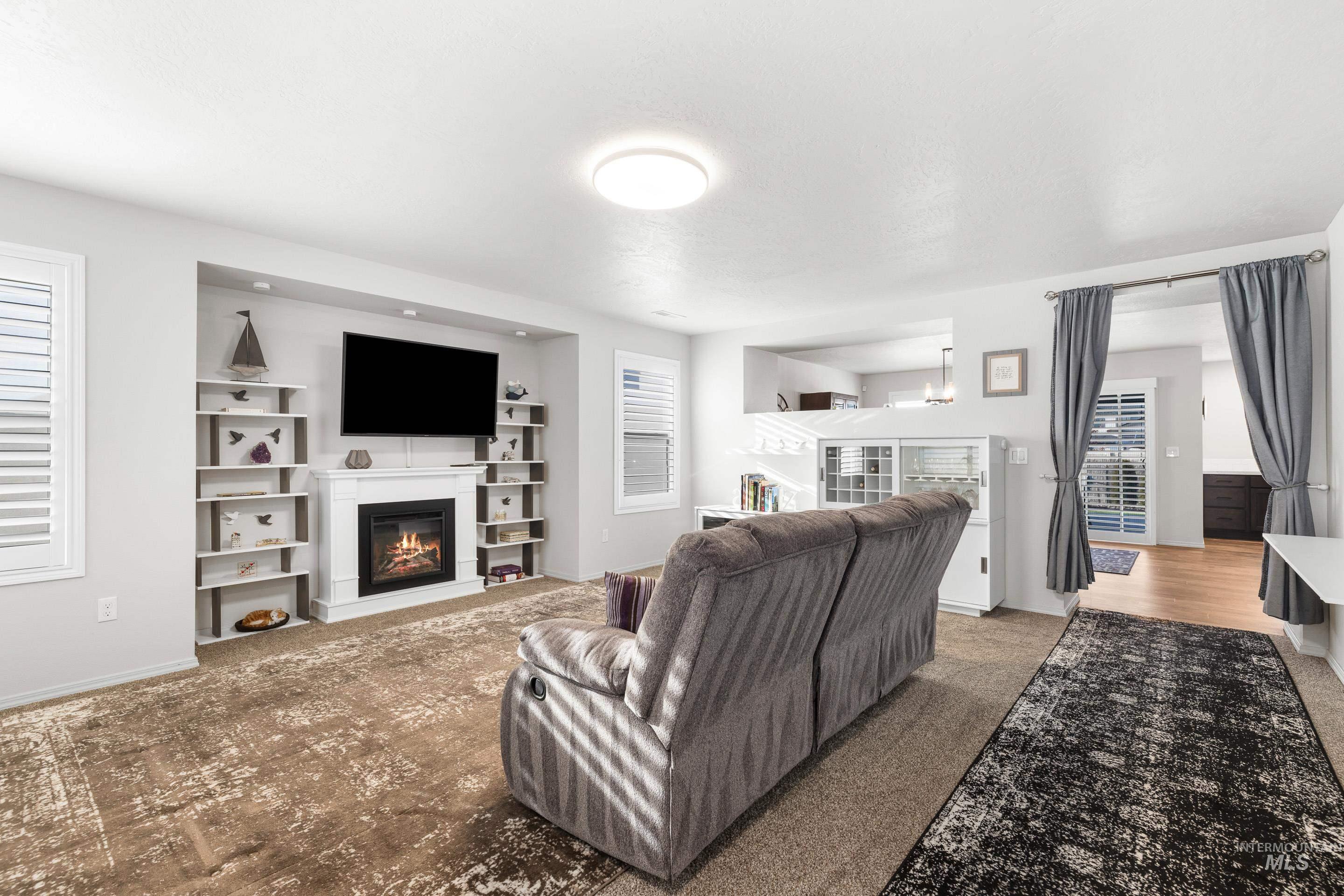 Living area featuring a glass covered fireplace