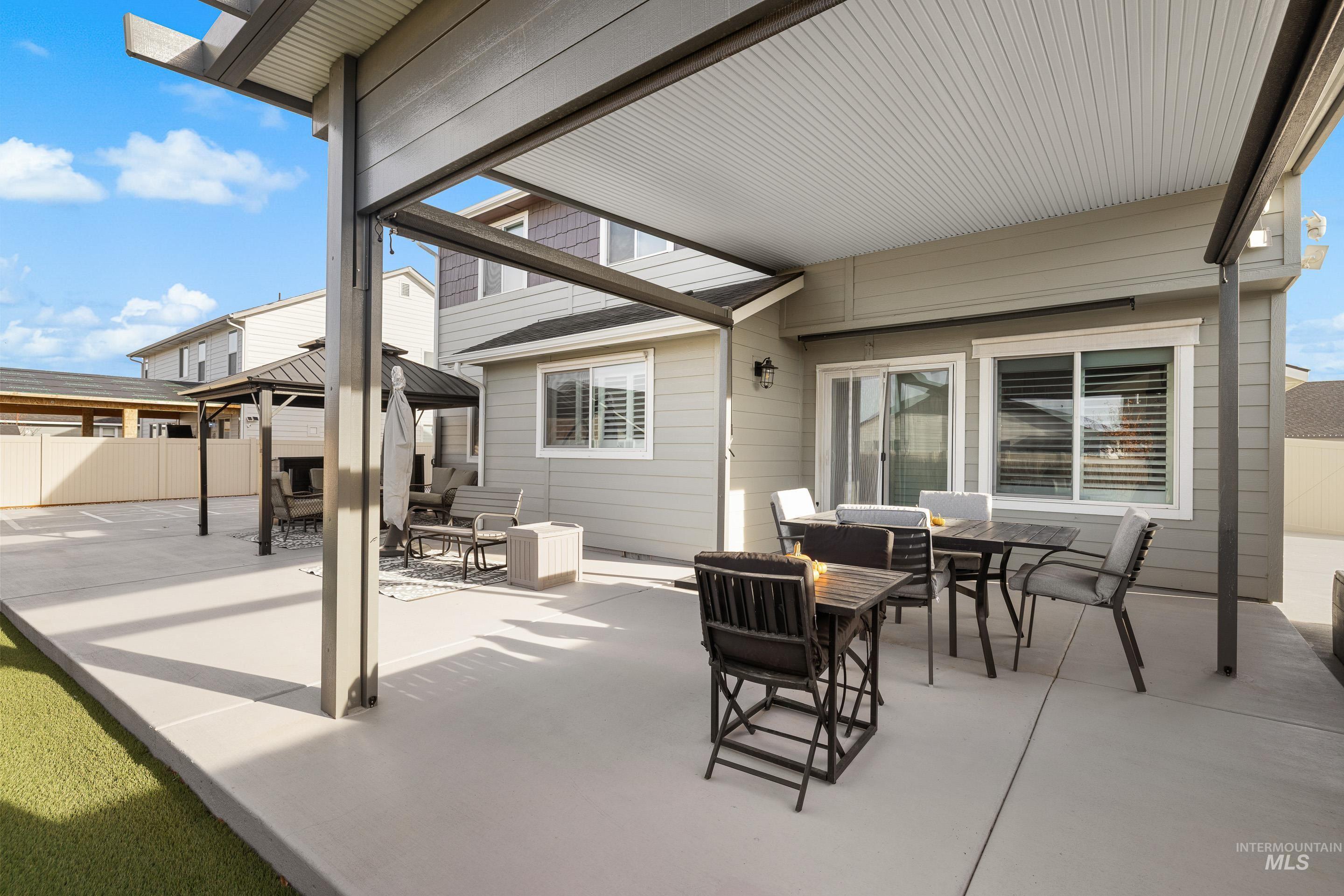 View of patio / terrace featuring outdoor dining area, an outdoor living space, and a gazebo