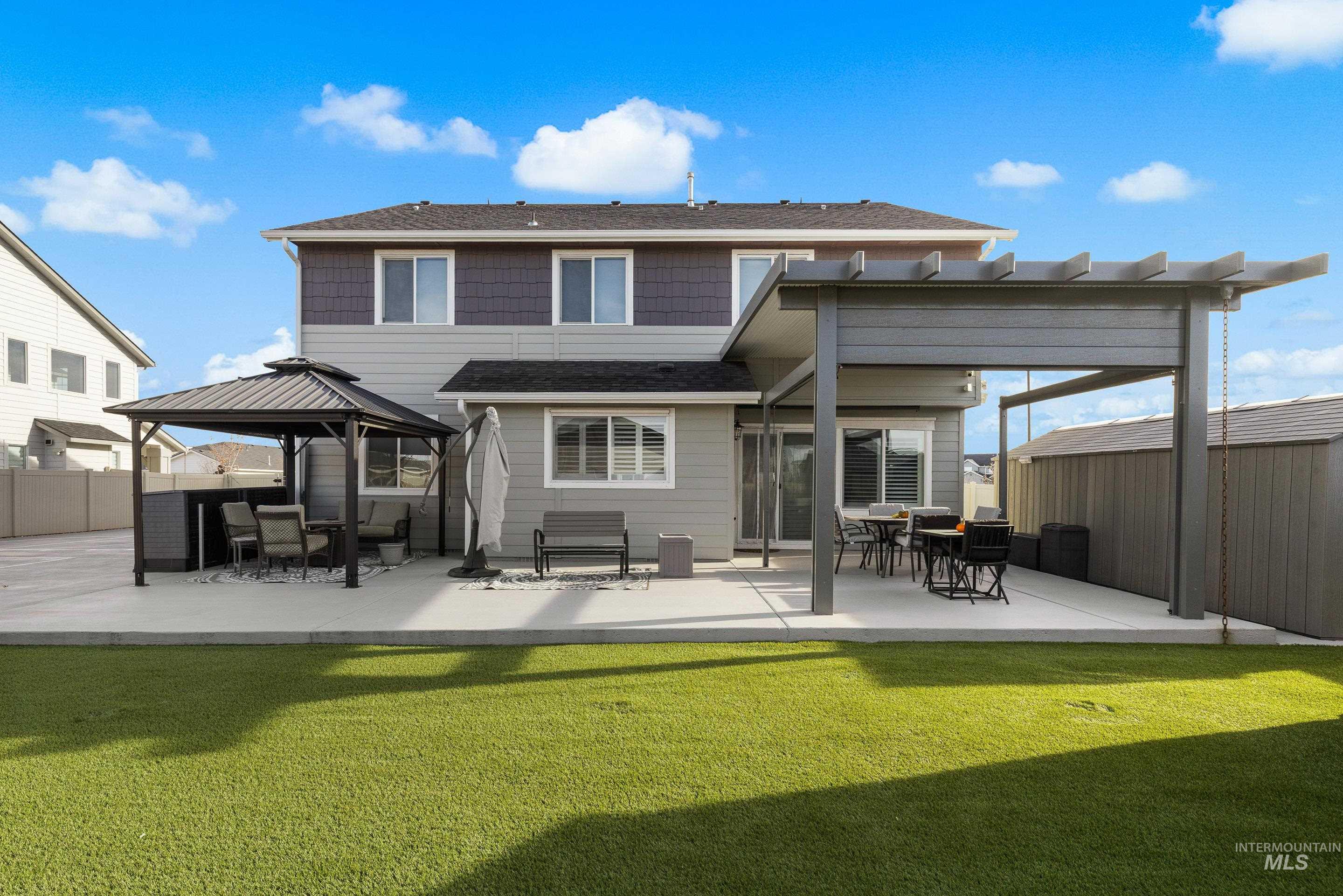 Rear view of property featuring a patio and a gazebo