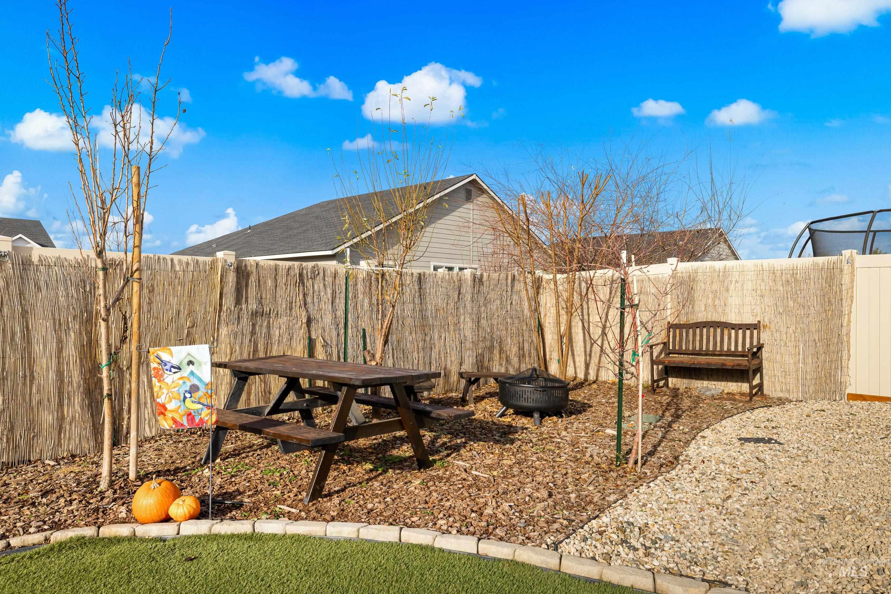 Fenced backyard with an outdoor fire pit