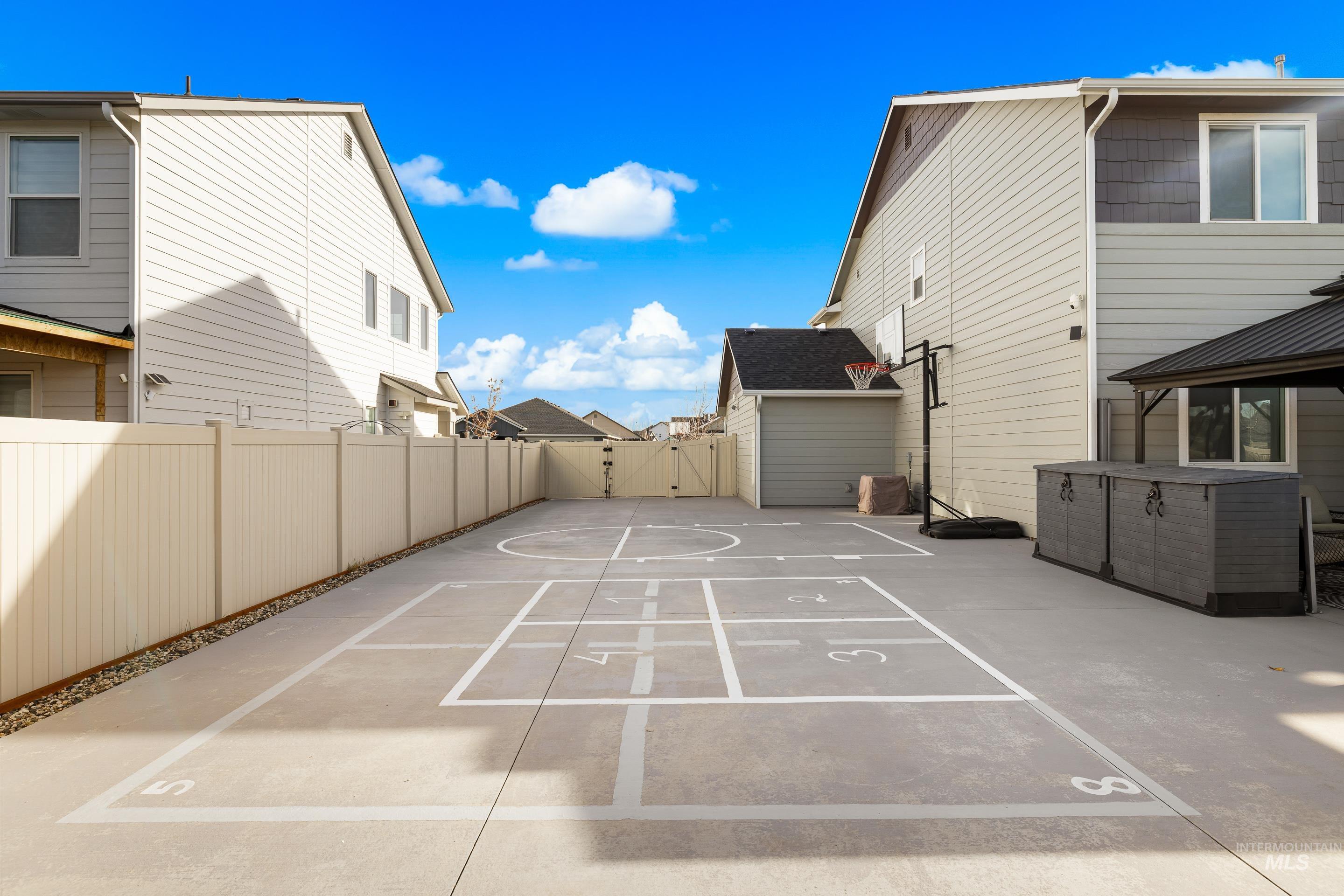 Fenced backyard featuring a residential view