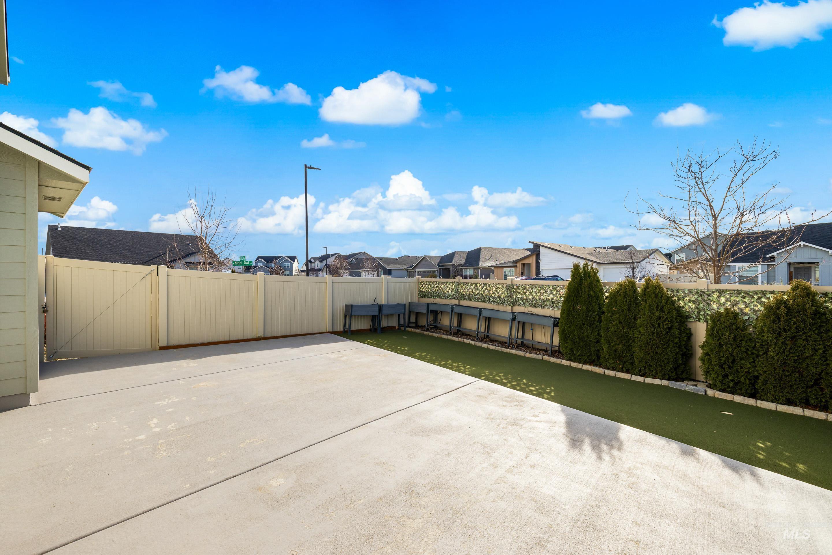 Fenced backyard featuring a residential view