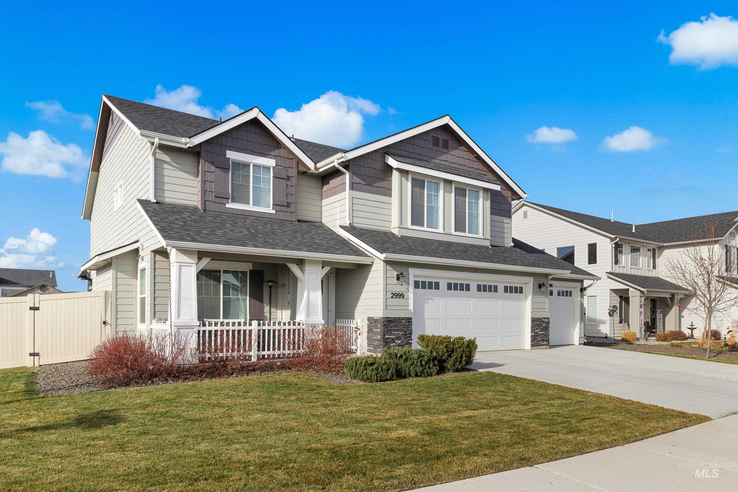 Craftsman inspired home with concrete driveway, a shingled roof, a garage, stone siding, and covered porch