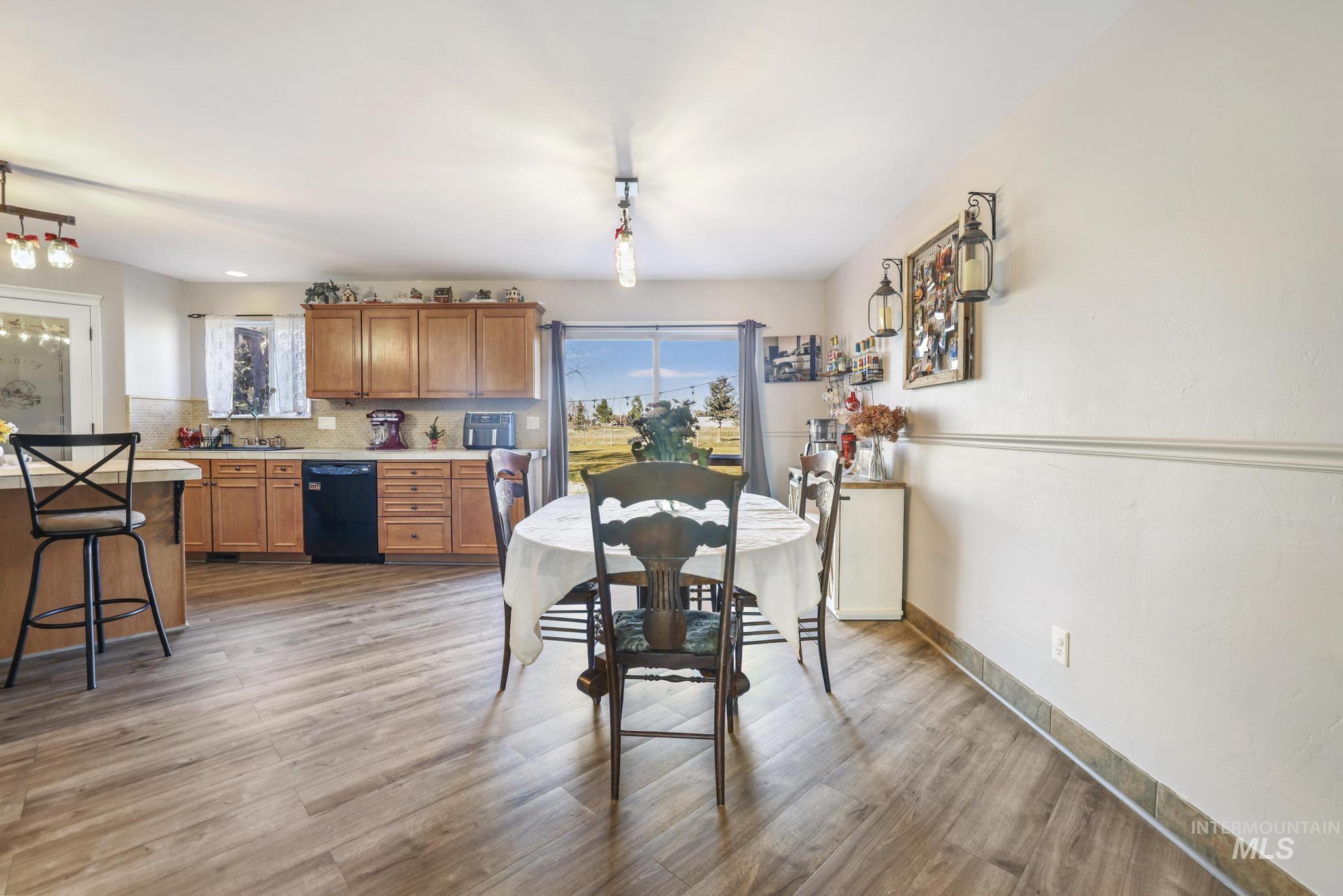 Dining room featuring light wood-style flooring and baseboards