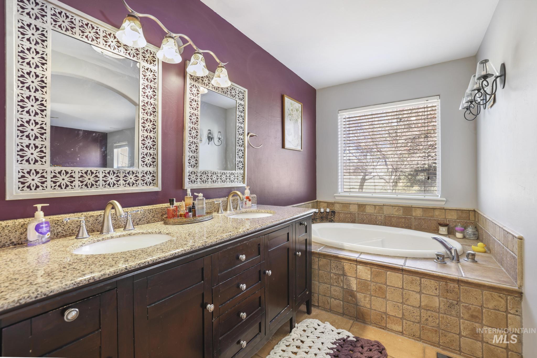 Full bathroom with double vanity and a garden tub