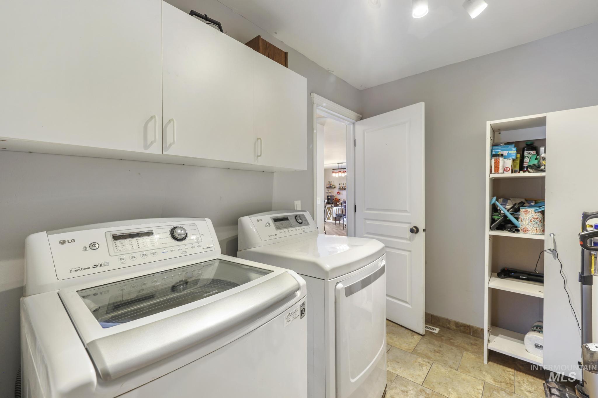 Laundry room with washing machine and clothes dryer and cabinet space
