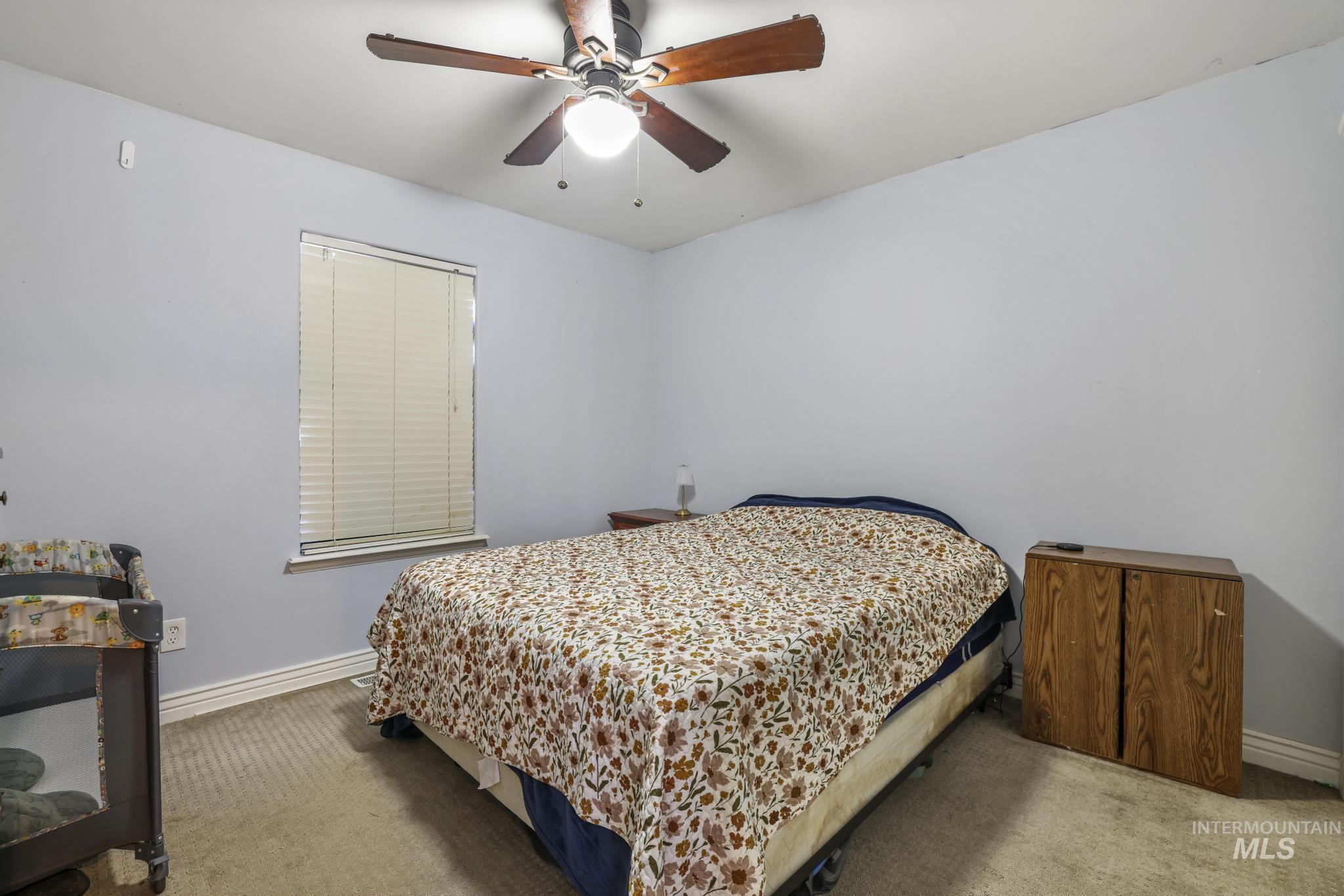 Bedroom featuring carpet floors and a ceiling fan