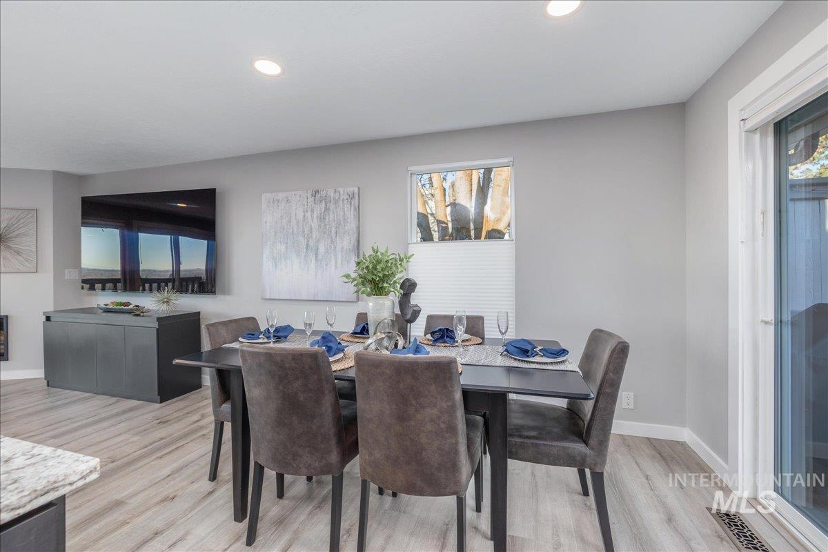 Dining area with light wood-style flooring, healthy amount of natural light, and recessed lighting