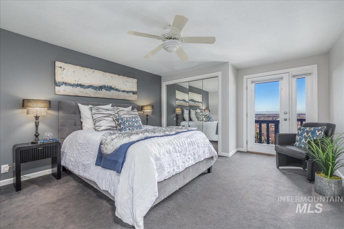 Carpeted bedroom featuring access to outside, ceiling fan, and a closet