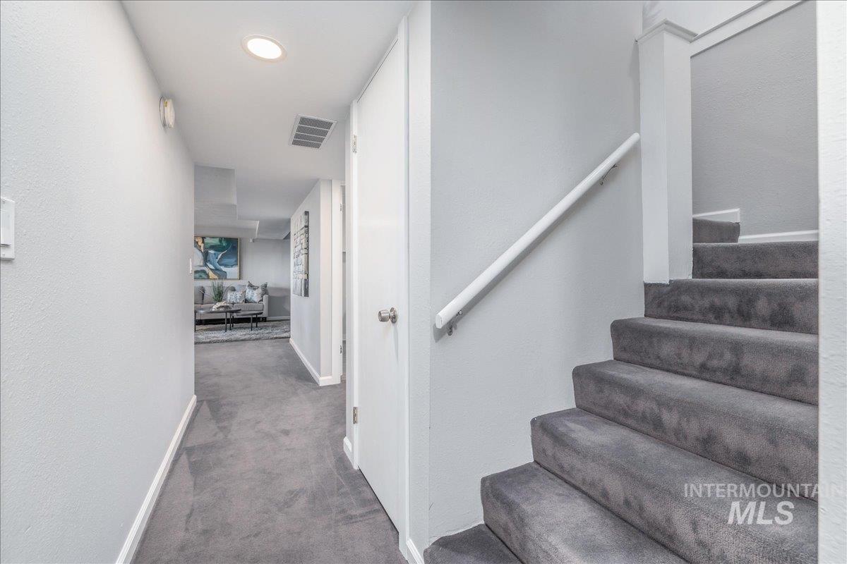 Stairs with carpet and recessed lighting