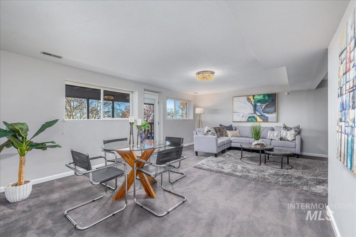 Dining space featuring baseboards and dark colored carpet