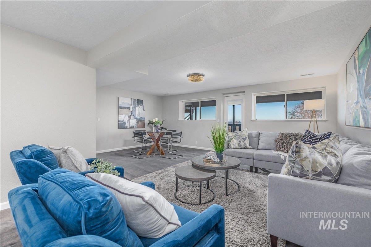 Living area featuring a textured ceiling and baseboards