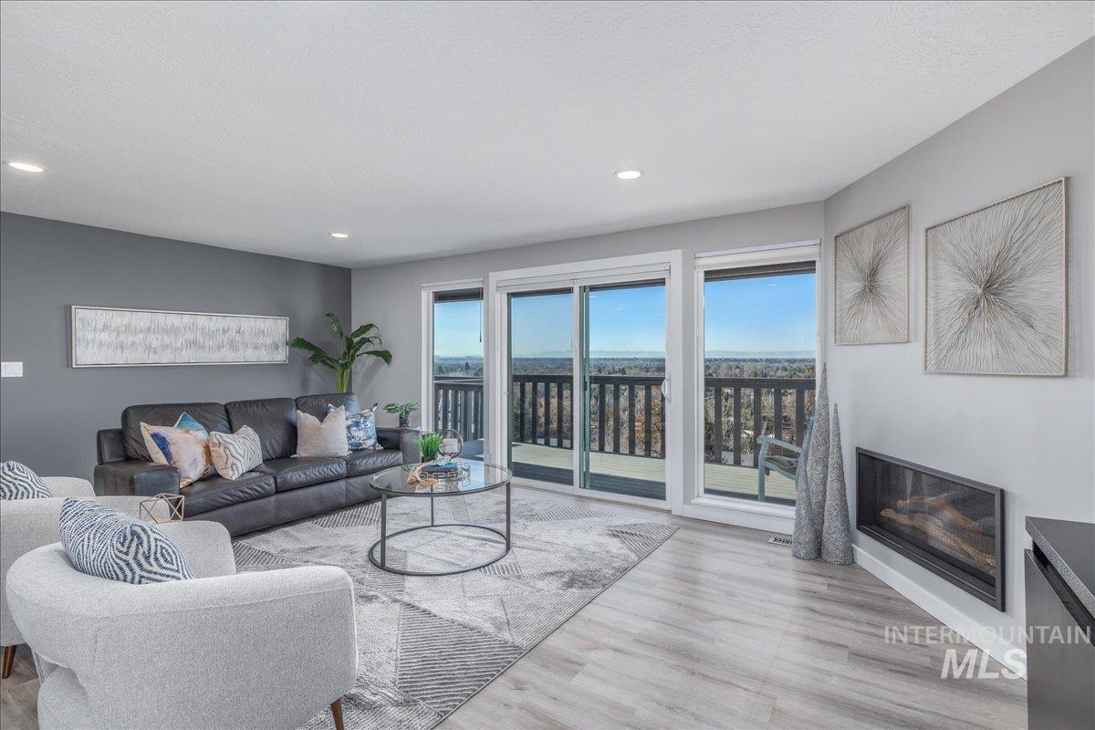 Living area with light wood-style flooring, plenty of natural light, and recessed lighting
