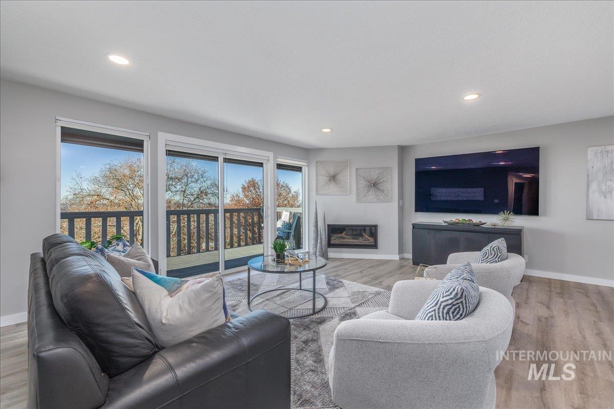 Living area with wood finished floors and recessed lighting