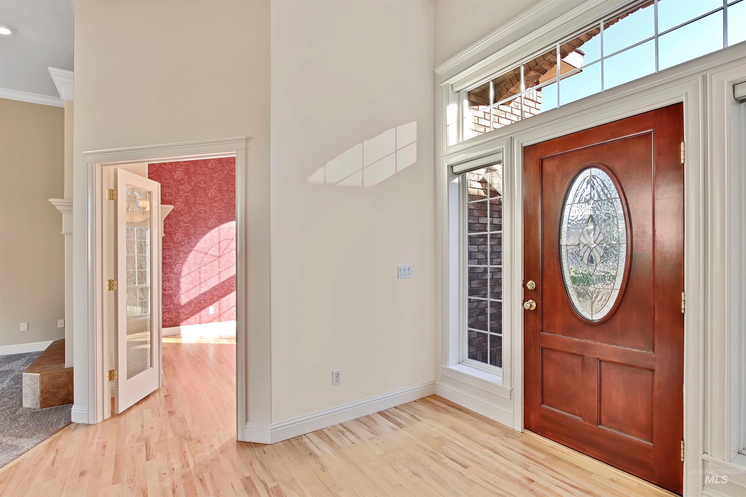 Entrance foyer with light wood-type flooring