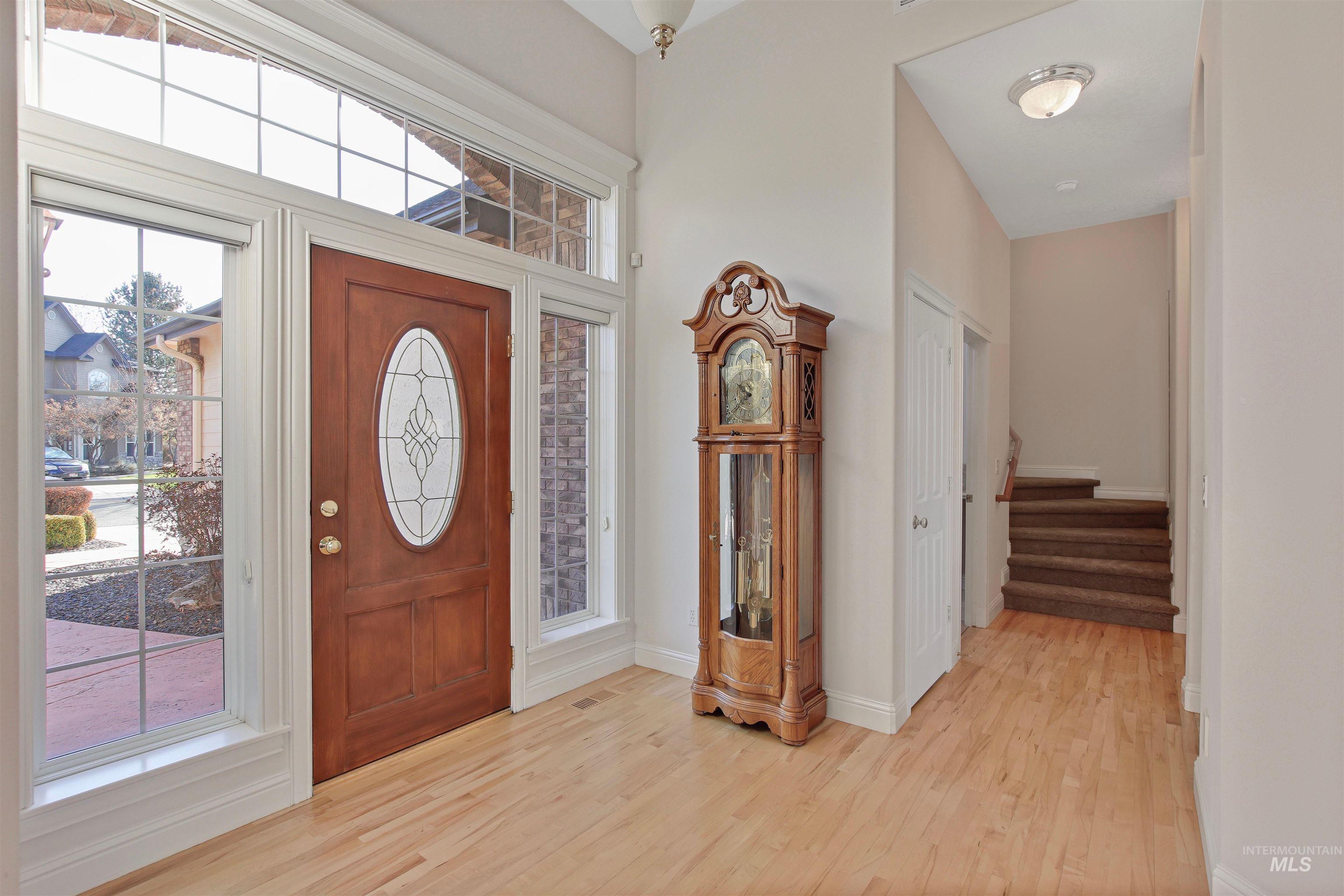 Foyer featuring stairway and light wood-style floors