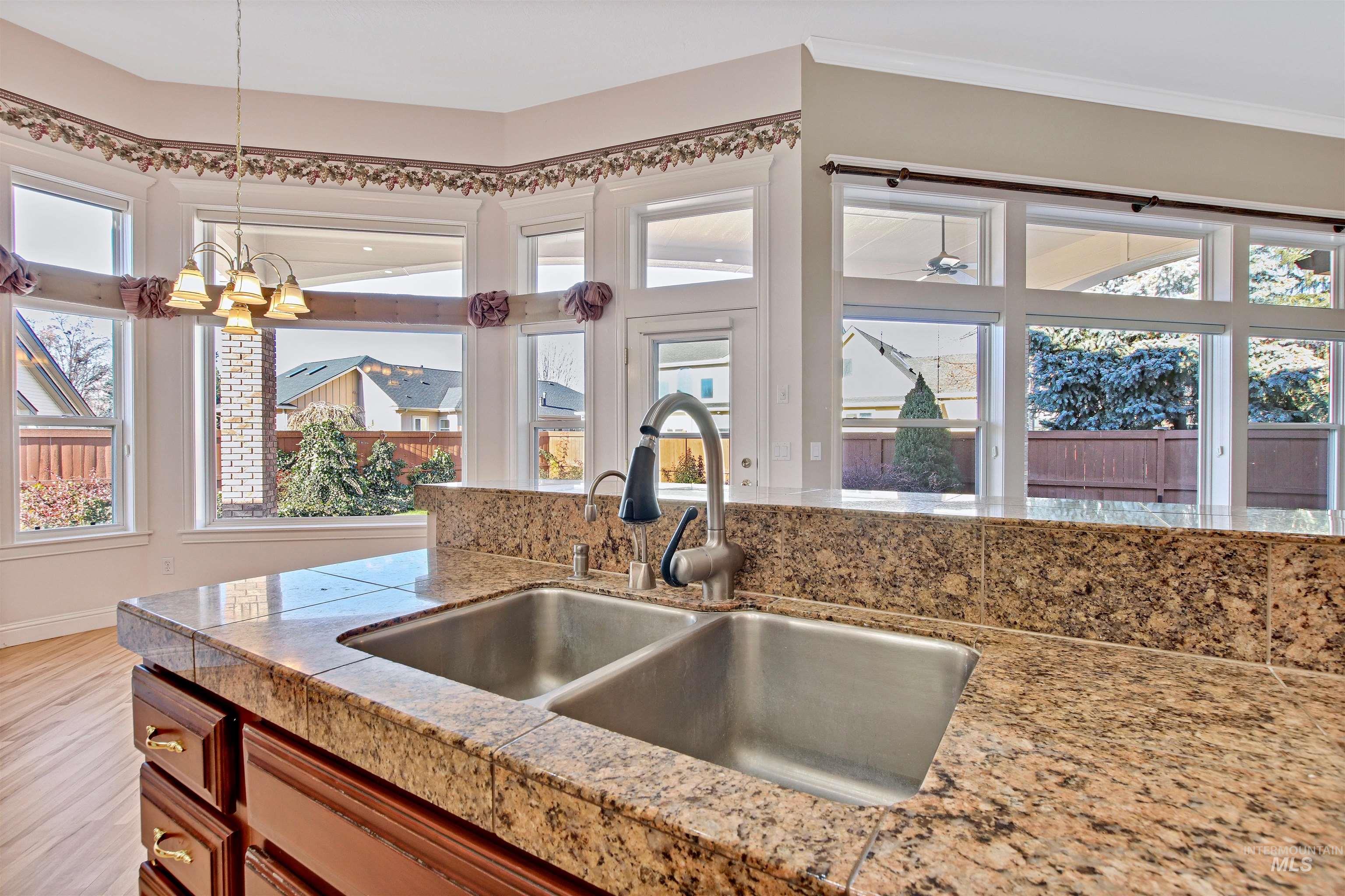 Kitchen featuring hanging light fixtures and tile countertops