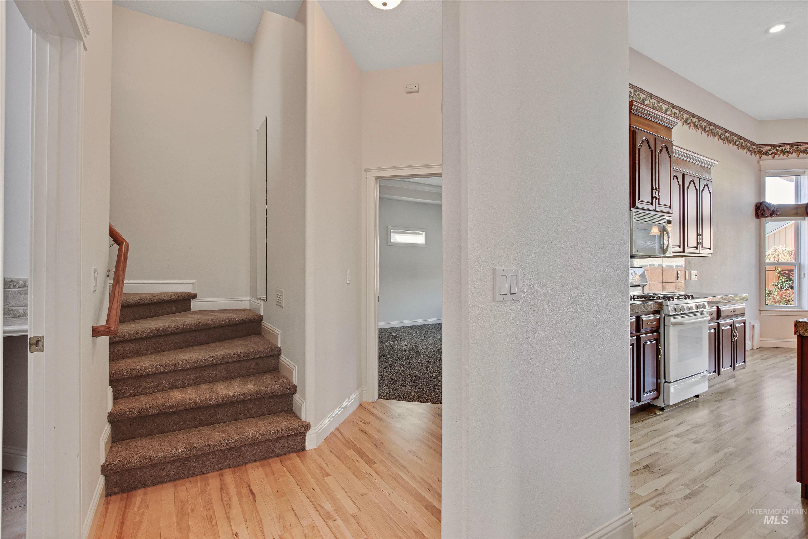 Staircase featuring wood finished floors