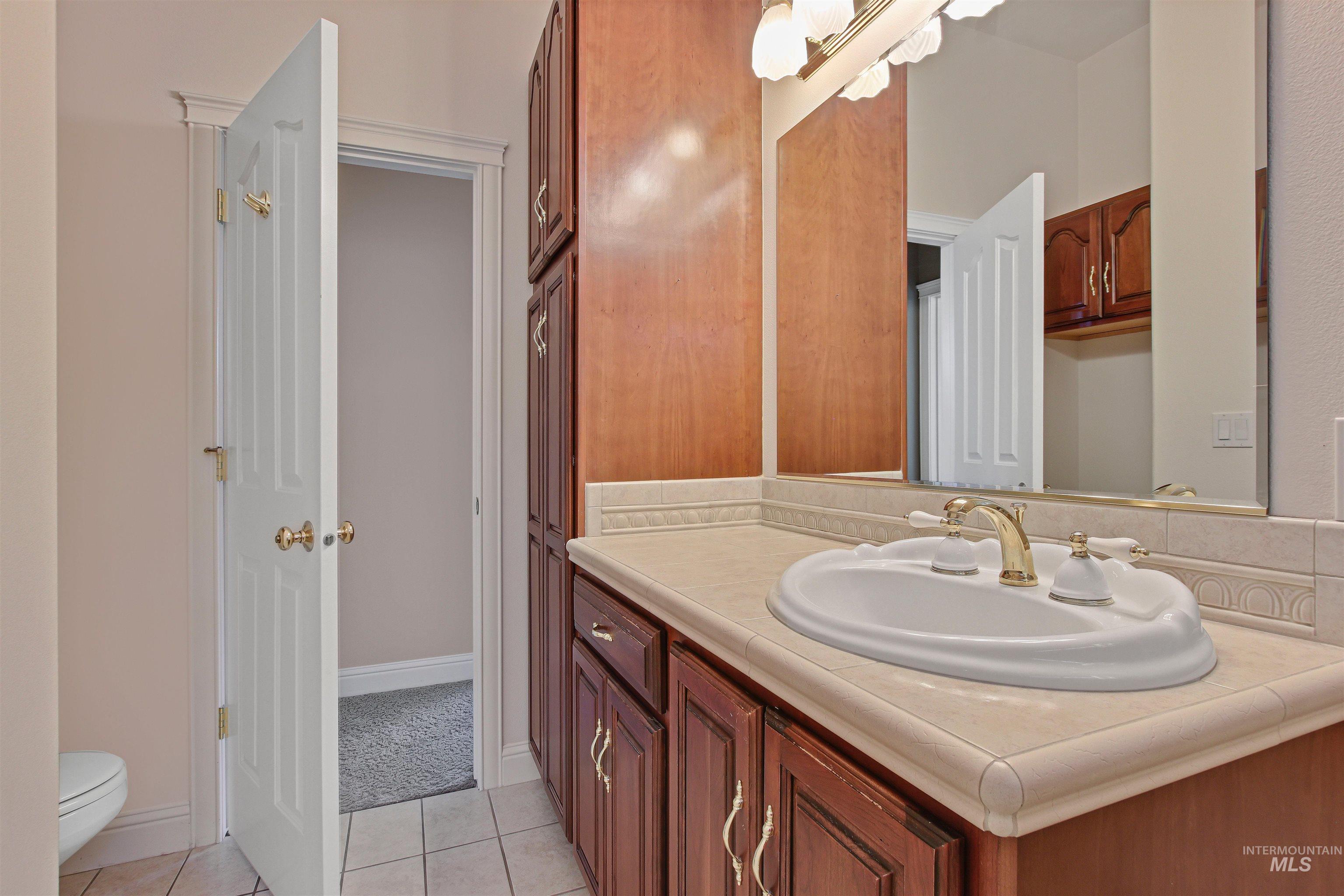 Bathroom featuring vanity and light tile patterned floors