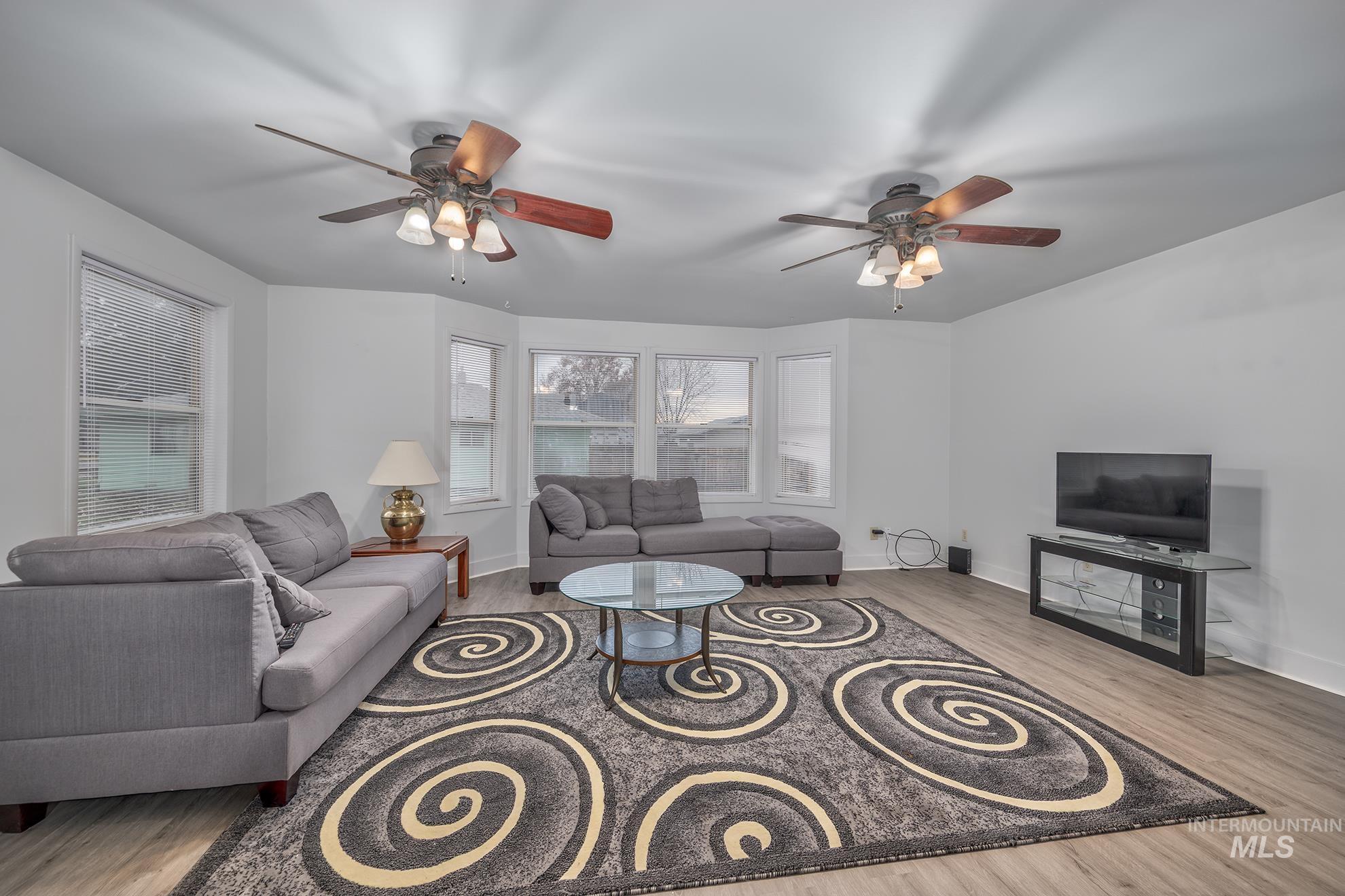 Living room featuring wood finished floors and ceiling fan
