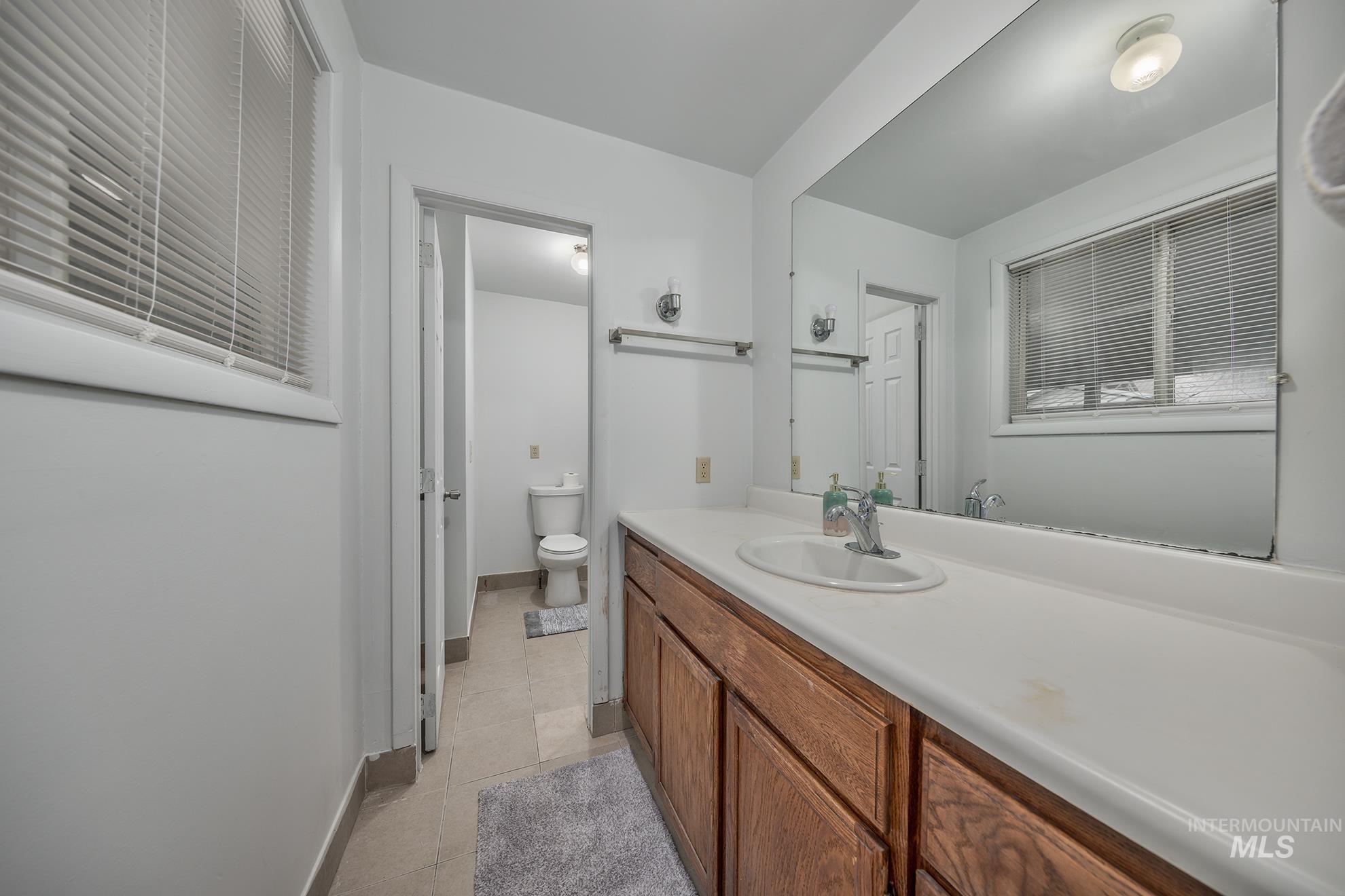 Bathroom featuring vanity and light tile patterned floors