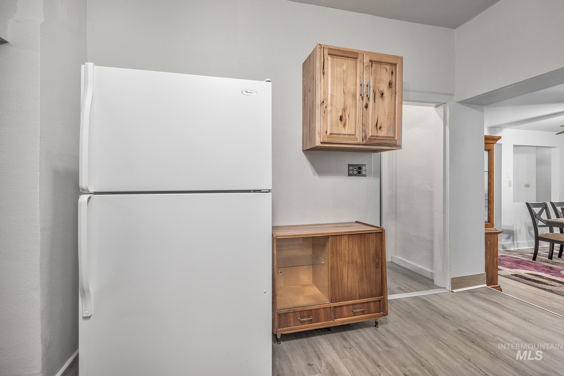 Kitchen featuring freestanding refrigerator and light wood-style flooring
