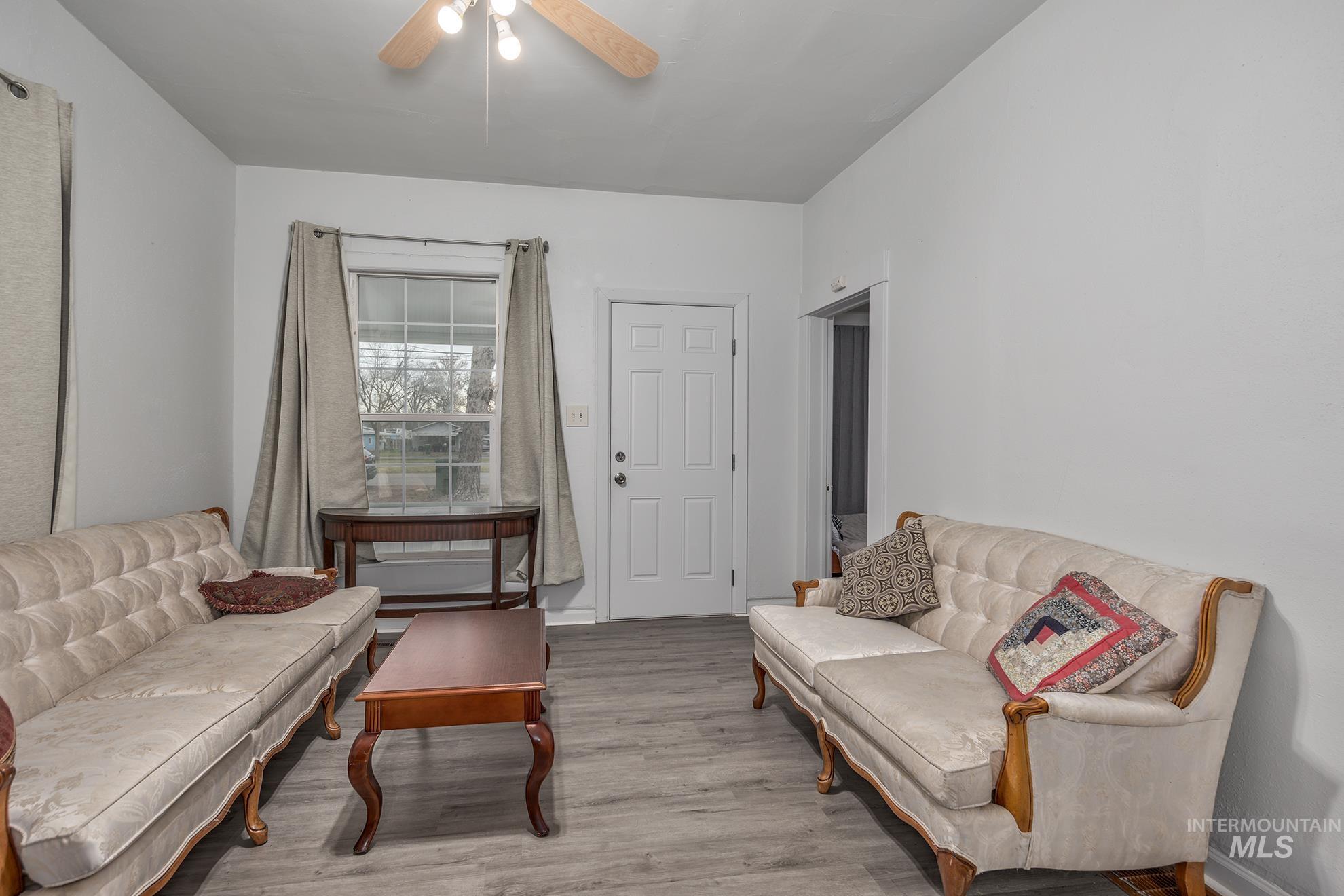 Sitting room featuring light wood finished floors and ceiling fan