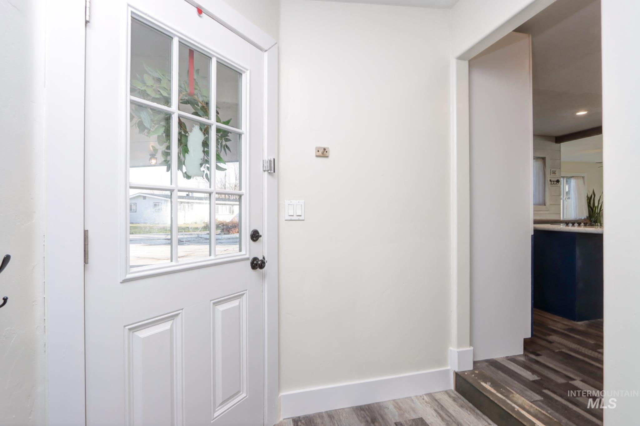 Doorway to outside featuring wood finished floors