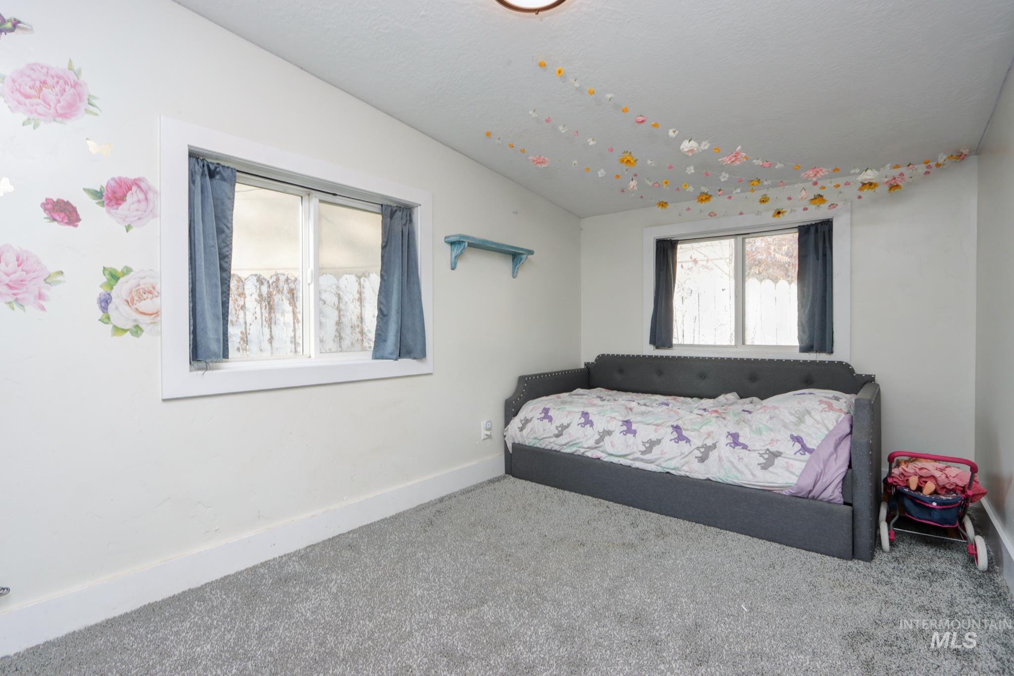 Carpeted bedroom featuring baseboards