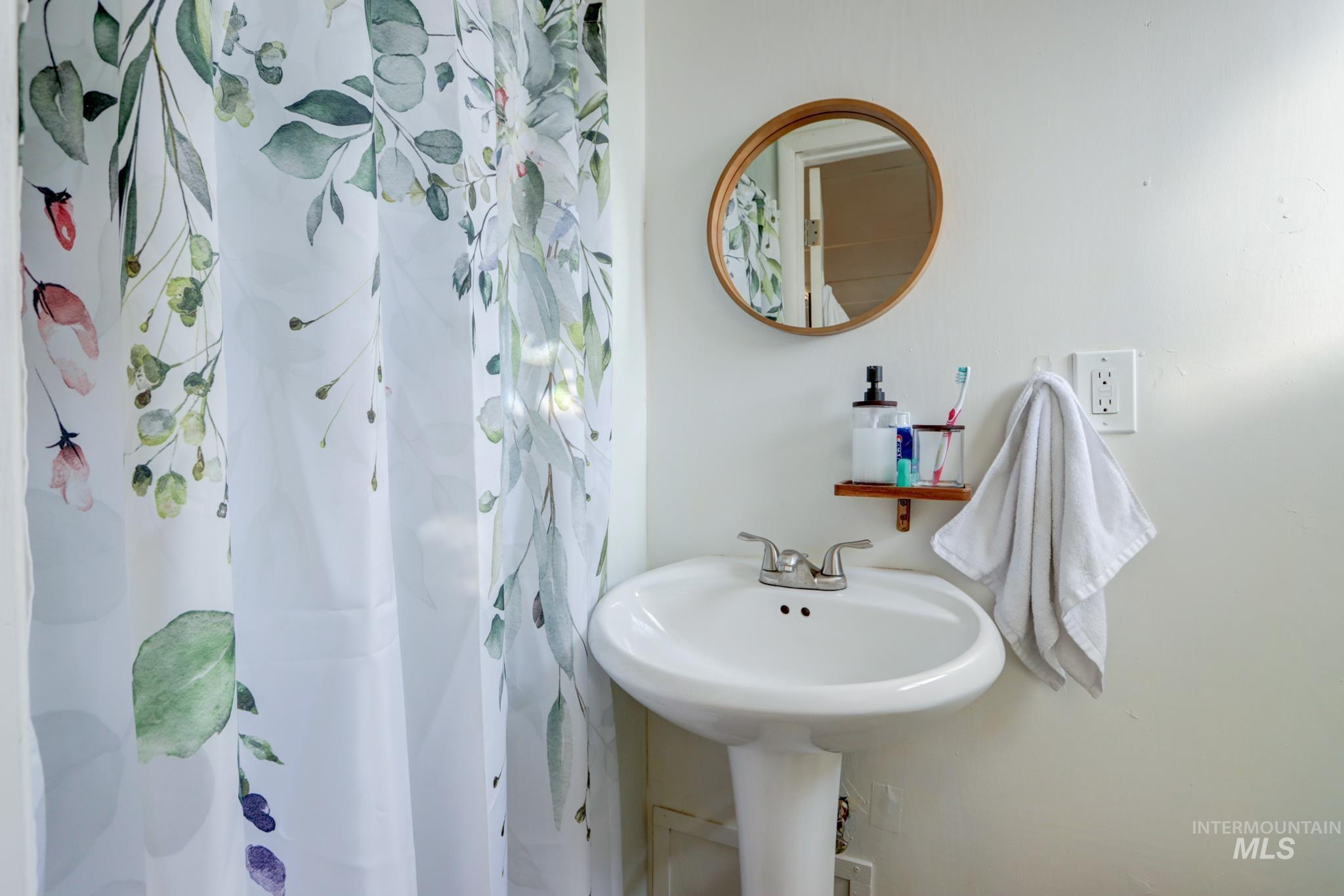 Bathroom with a shower with shower curtain