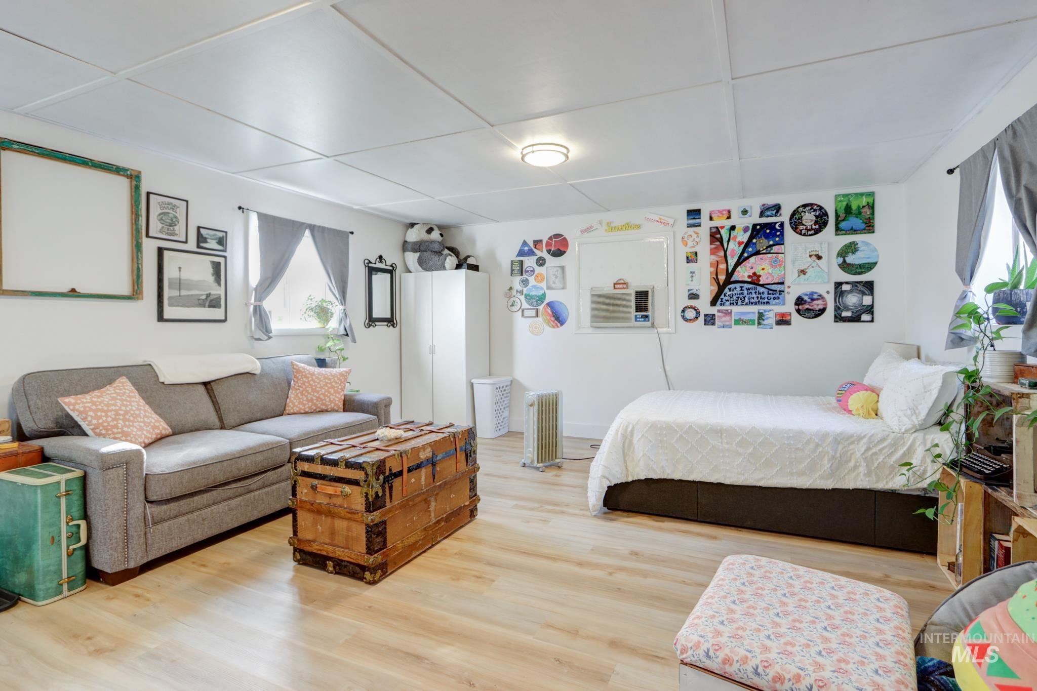 Bedroom with radiator and light wood-type flooring