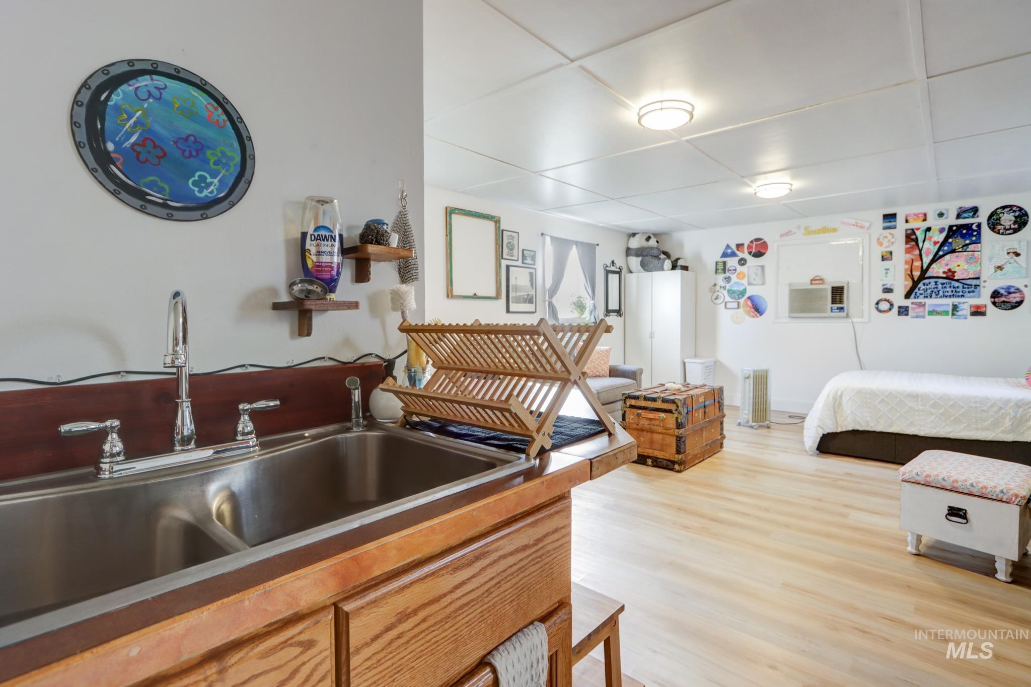 Bedroom with a sink and light wood-style floors