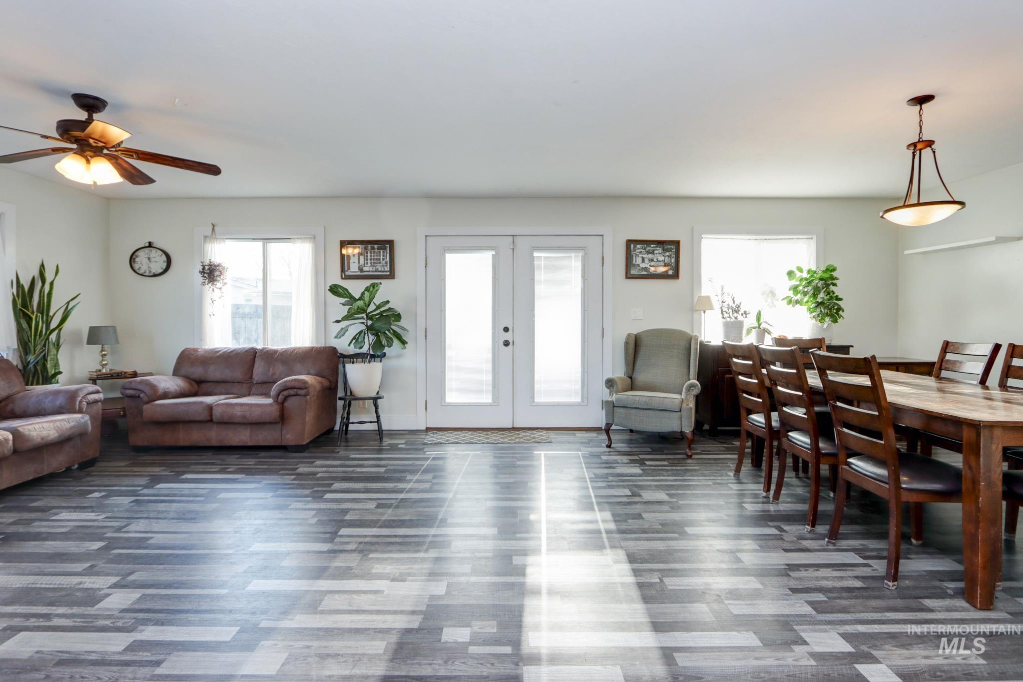 Living room featuring french doors and a ceiling fan