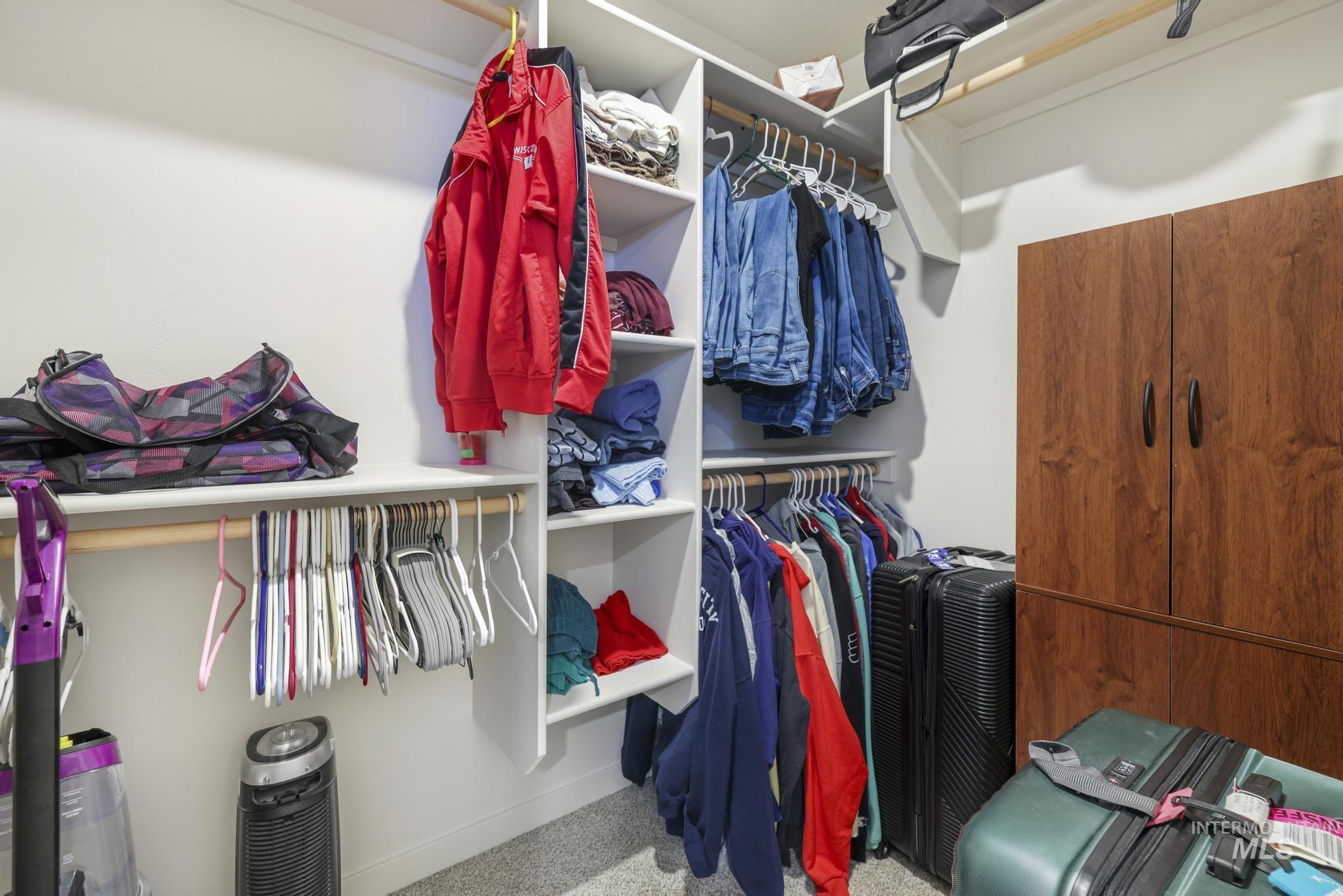 Spacious closet with carpet floors