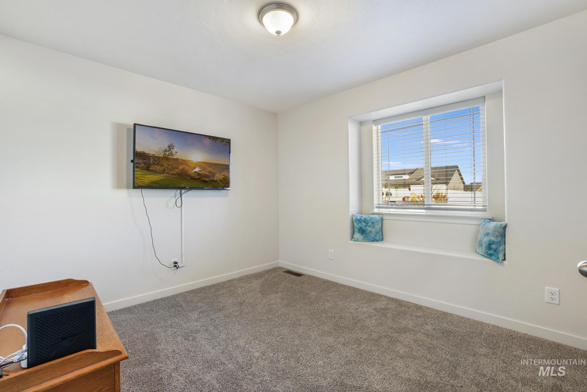 Unfurnished room with baseboards and carpet