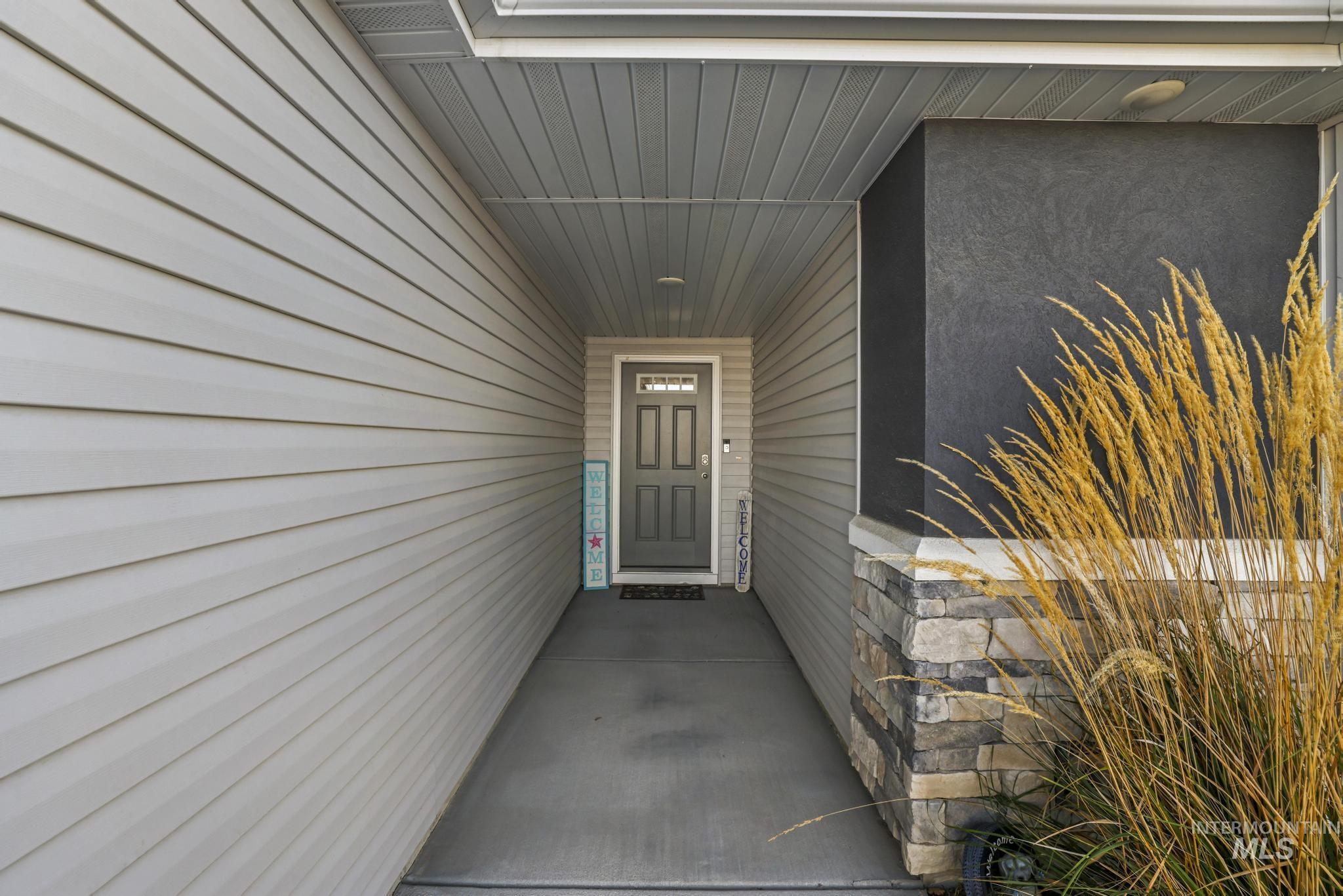 Property entrance featuring stucco siding