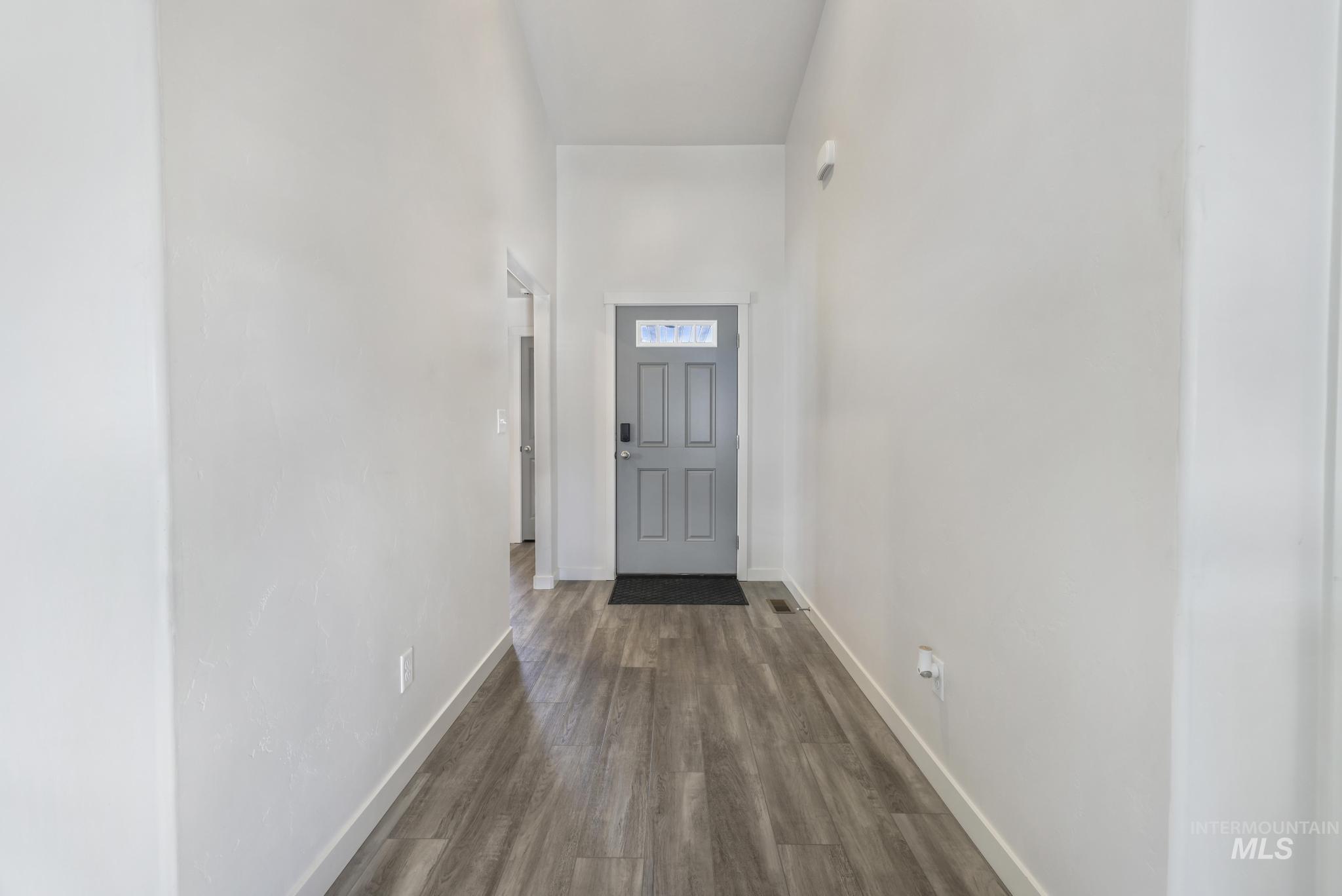 Entryway featuring wood finished floors and a high ceiling