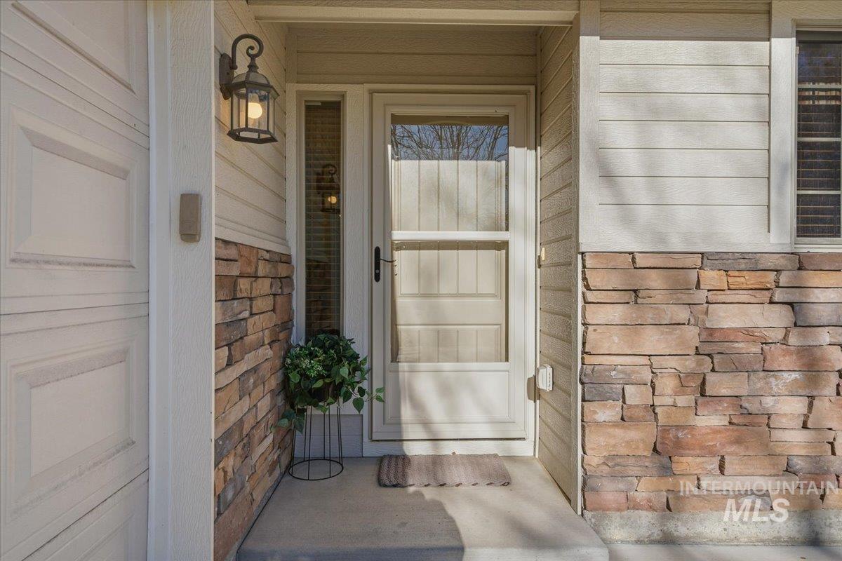 Doorway to property with stone siding
