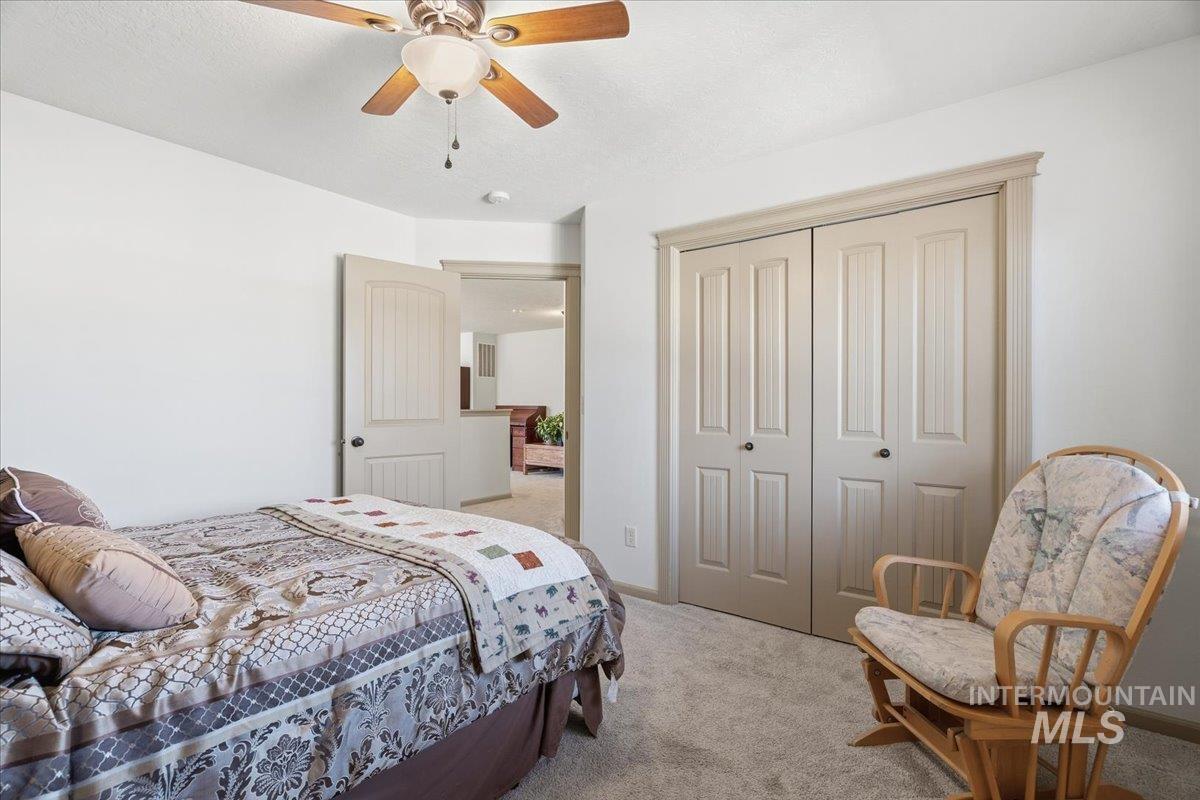 Bedroom featuring carpet, a closet, and a ceiling fan