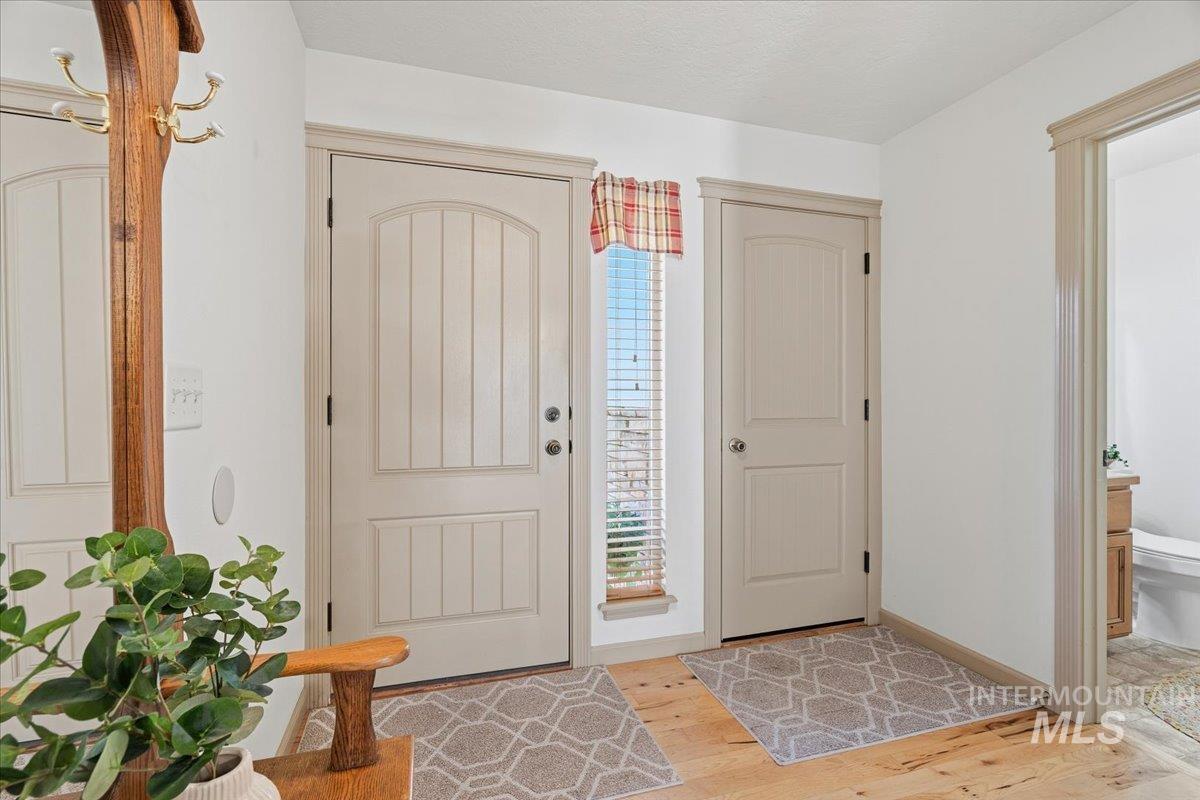 Entrance foyer featuring light wood-type flooring and baseboards