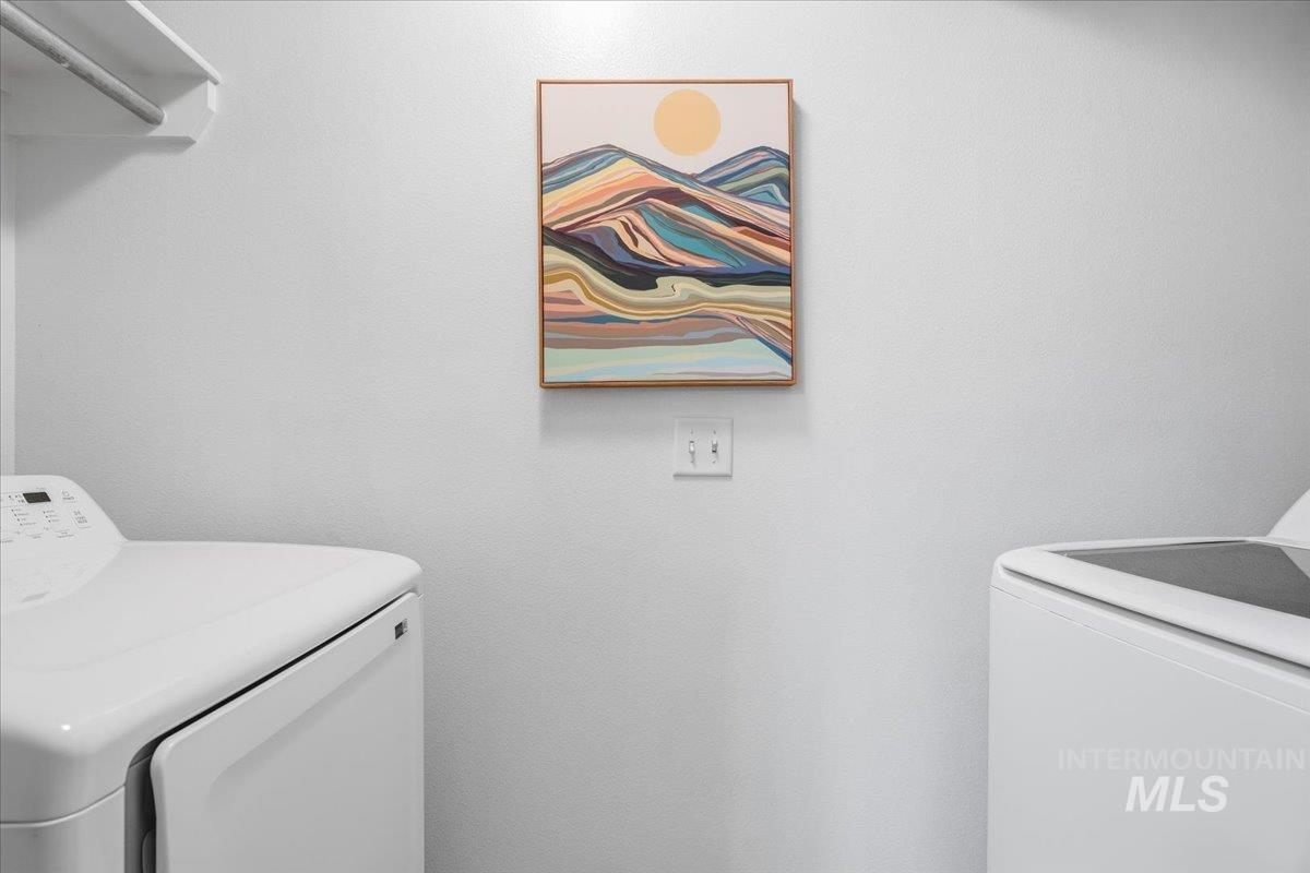 Washroom featuring washing machine and dryer