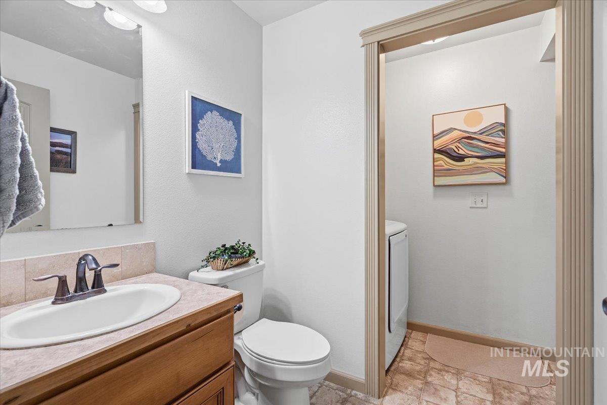 Half bathroom with vanity and washer / dryer