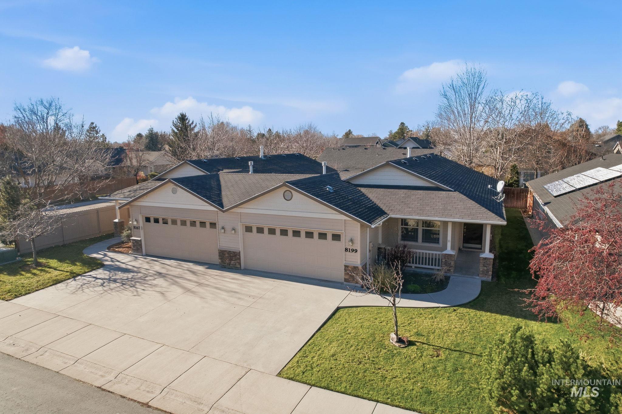 Single story home featuring stone siding, concrete driveway, a porch, and an attached garage