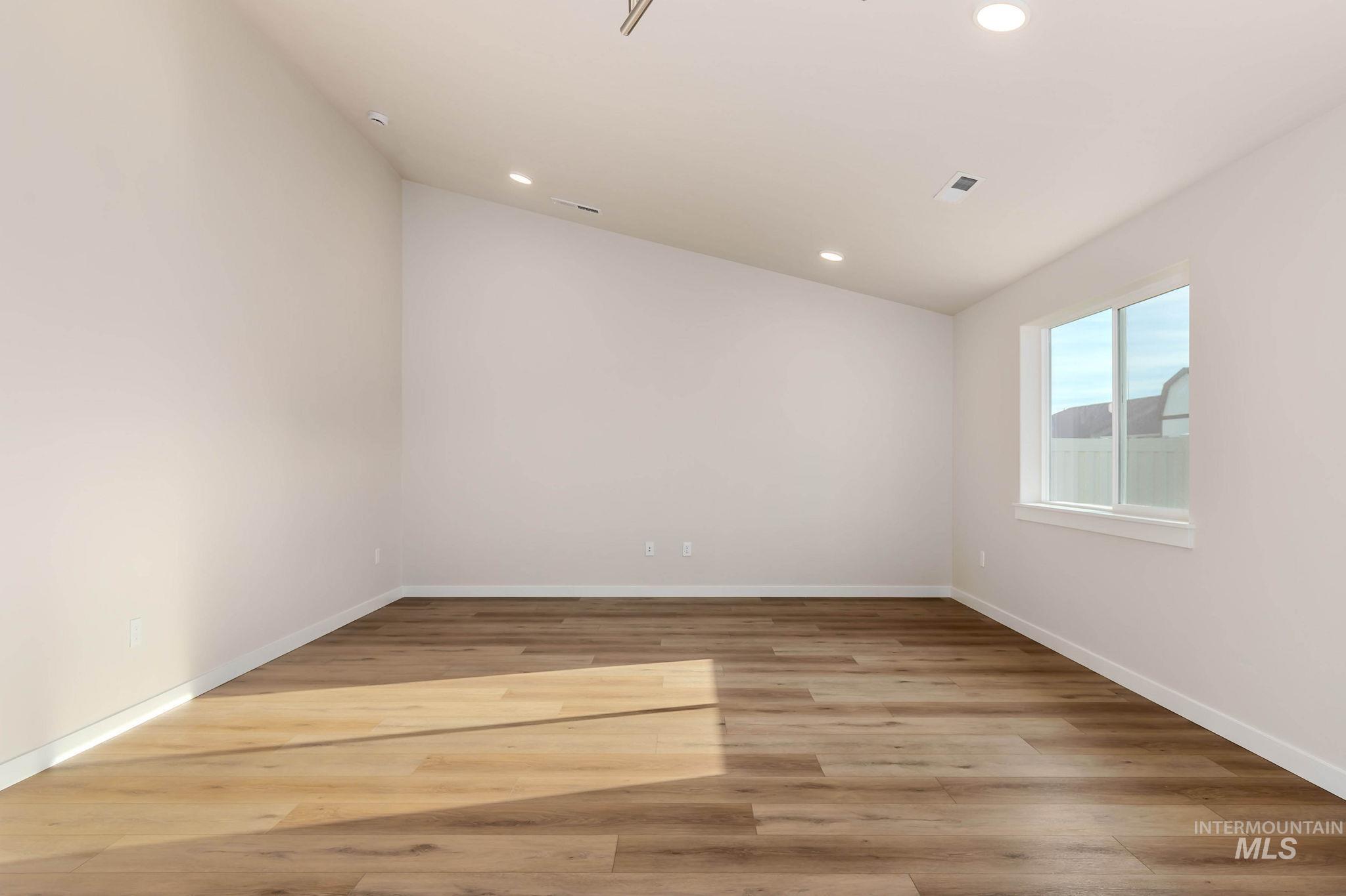 Spare room featuring light wood finished floors and recessed lighting