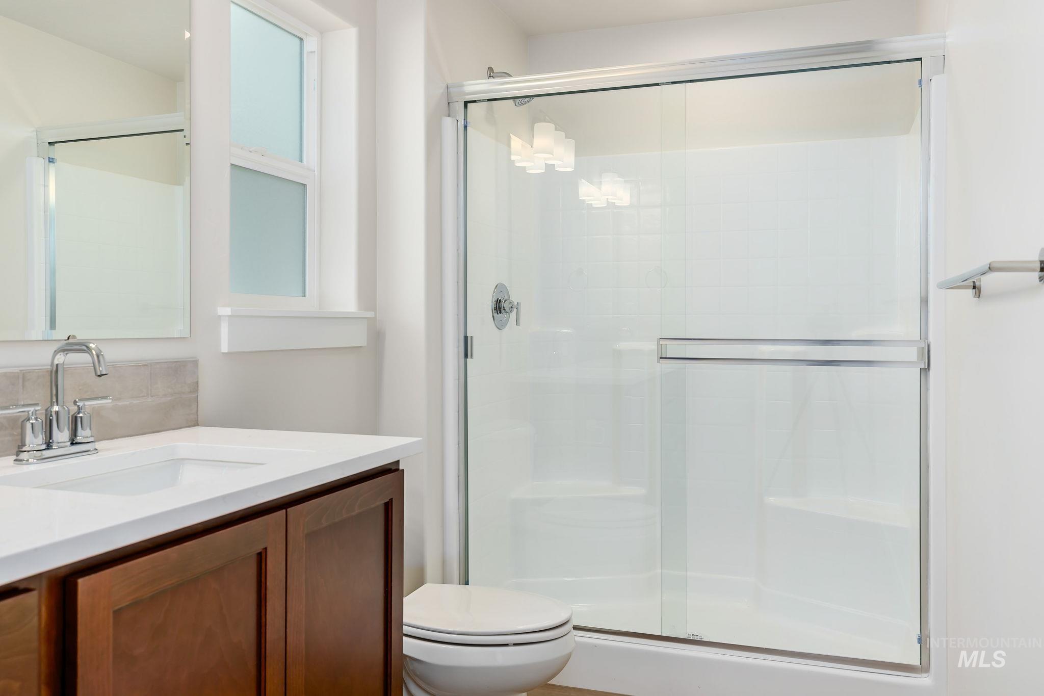 Bathroom with vanity and a shower stall