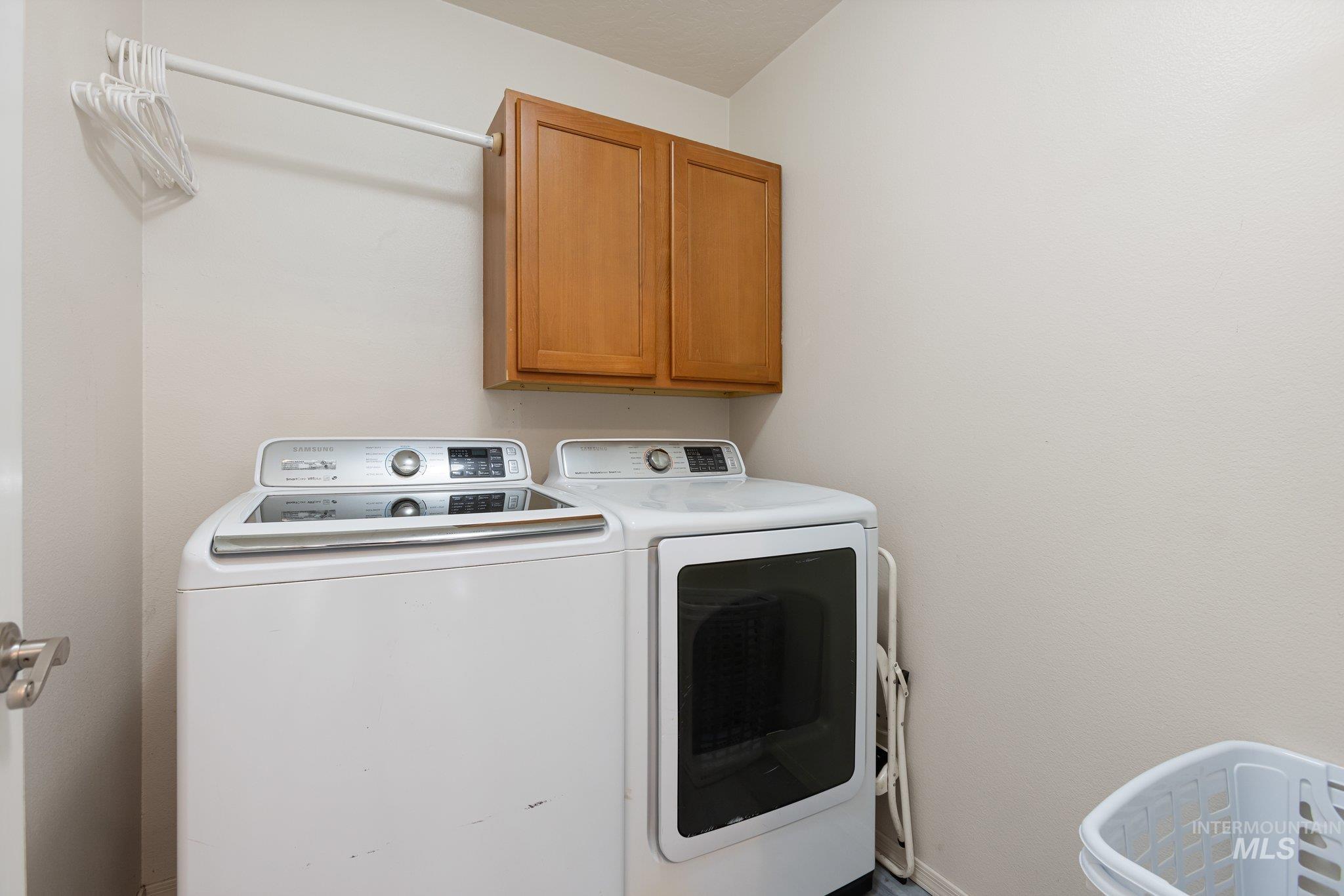 Washroom with cabinet space and independent washer and dryer