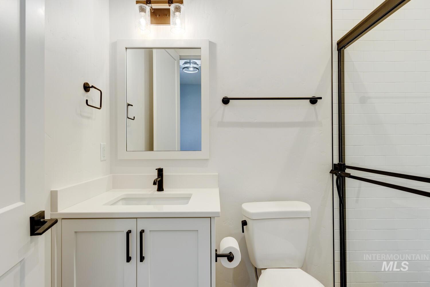 Bathroom with an enclosed shower and vanity